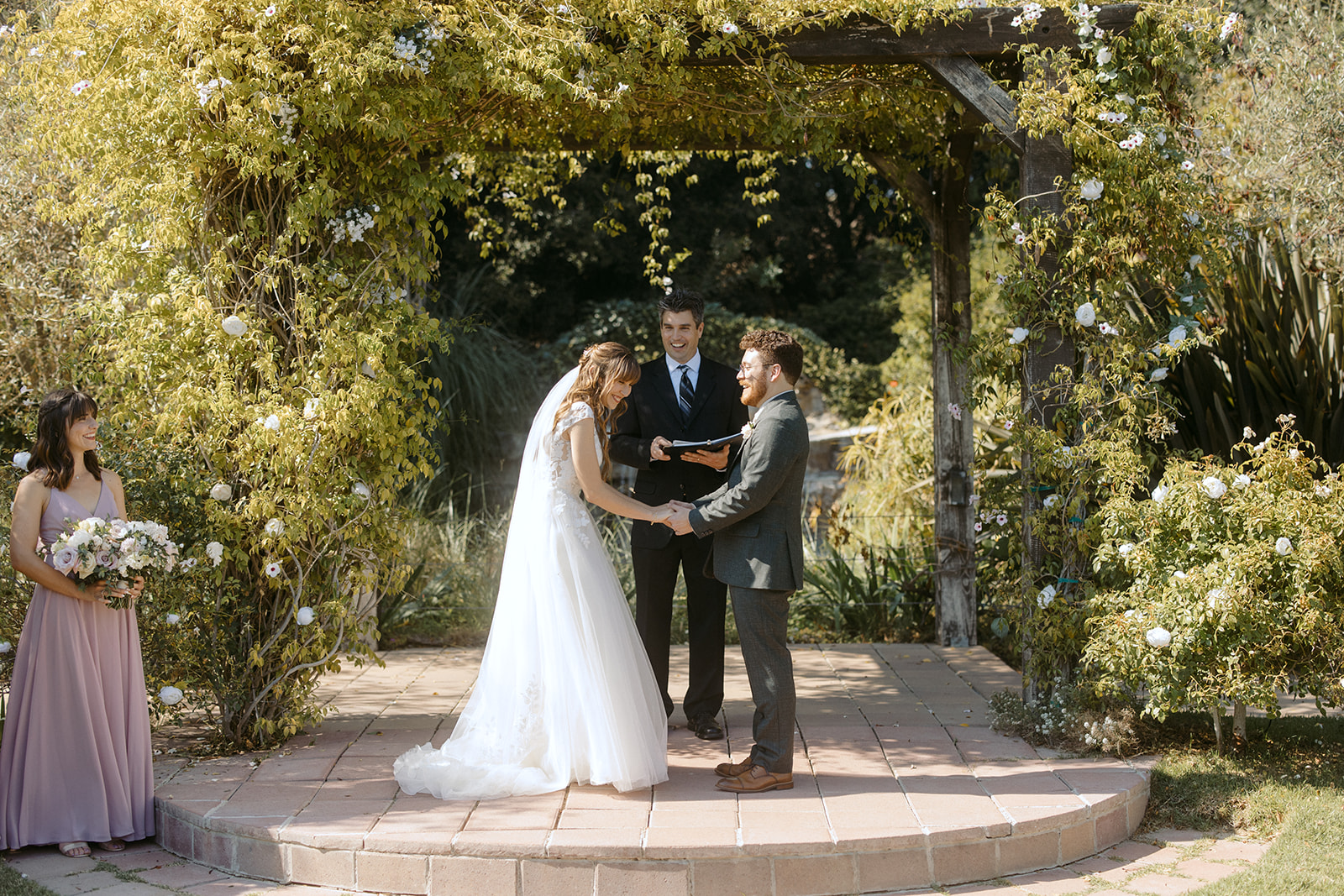 Bride and groom laughing during wedding ceremony at La Arboleda in California