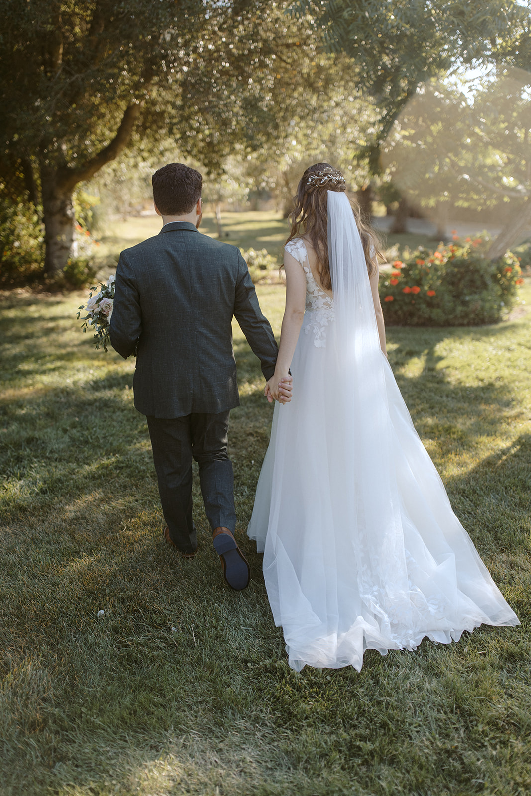 Bride and groom walk away at La Arboleda in California