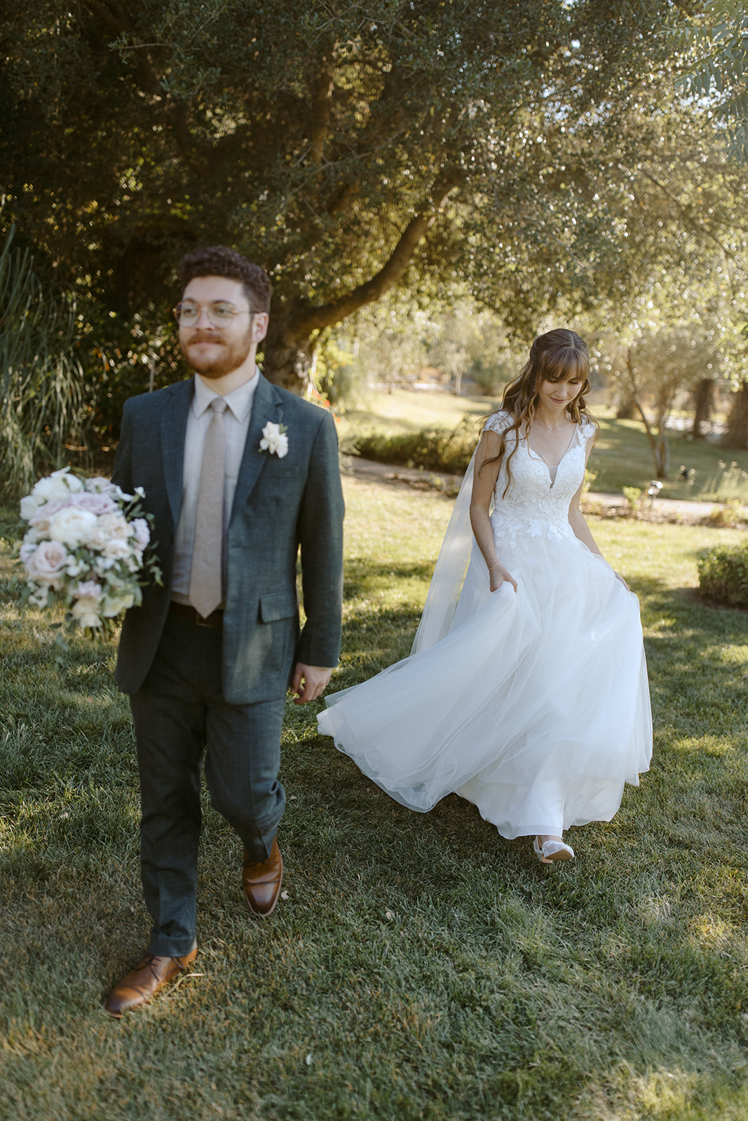 Bride and groom walk forward at La Arboleda in California