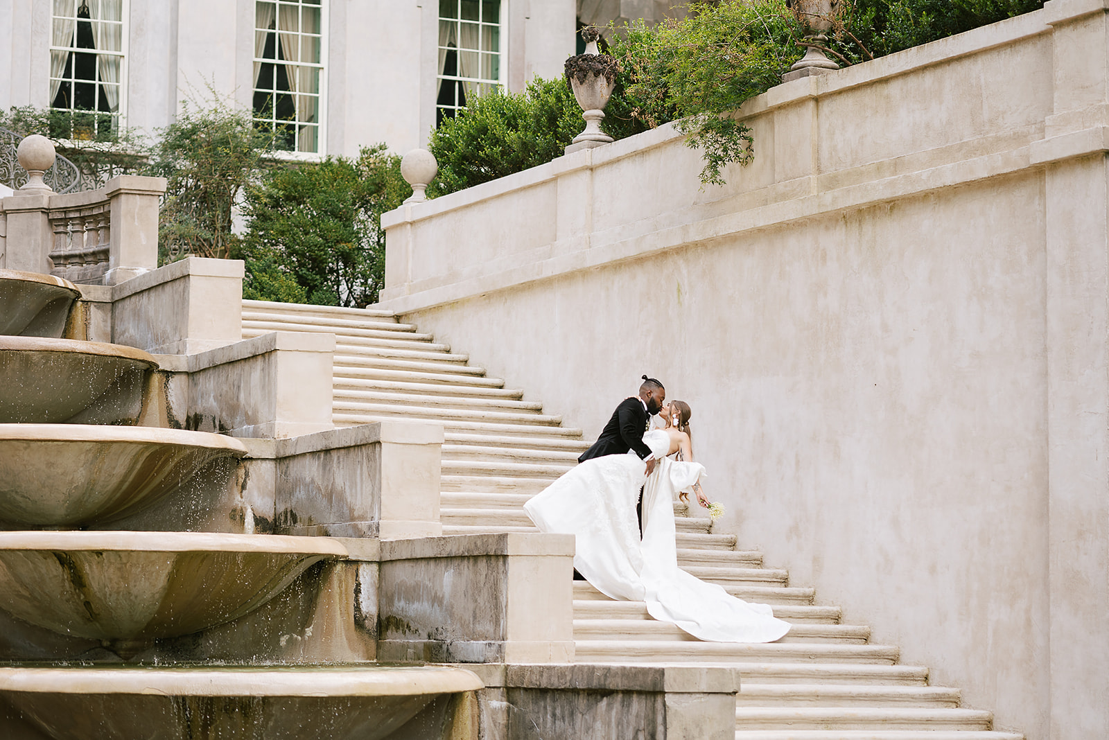 BRIDE AND GROOM ON THE STEPS OF THE SWAN HOUSE IN ATLANTA, GA FOR AN EDITORIAL SHOOT