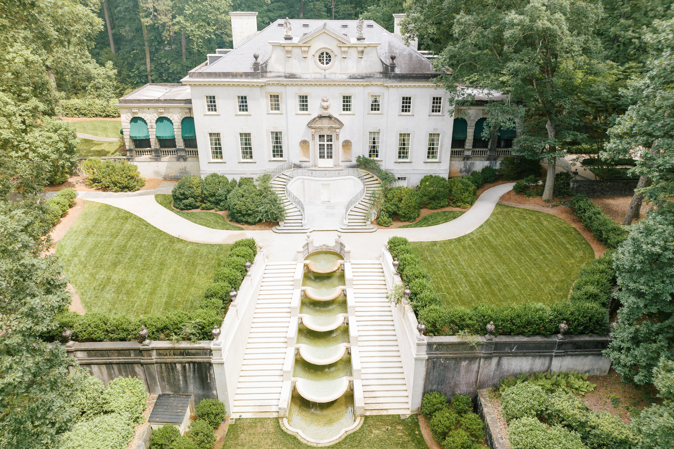 A SWAN HOUSE ANNIVERSARY EDITORIAL IN ATLANTA, GA DRONE AERIAL SHOT OF THE LANDSCAPE OF THE HOUSE AND THE WATERFALLS