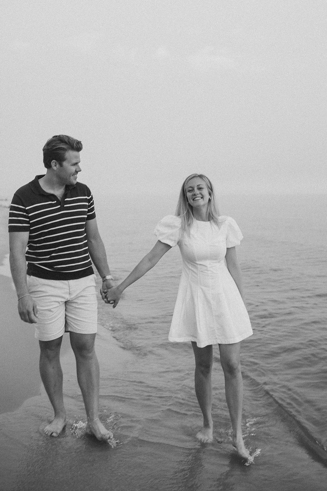 Black & white documentary style engagement photos by the beach