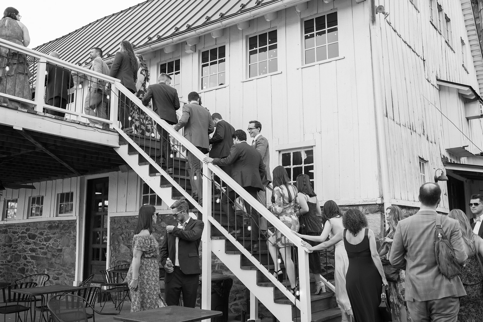 Guests walk up the stairs to cocktail hour at Loudoun County wedding