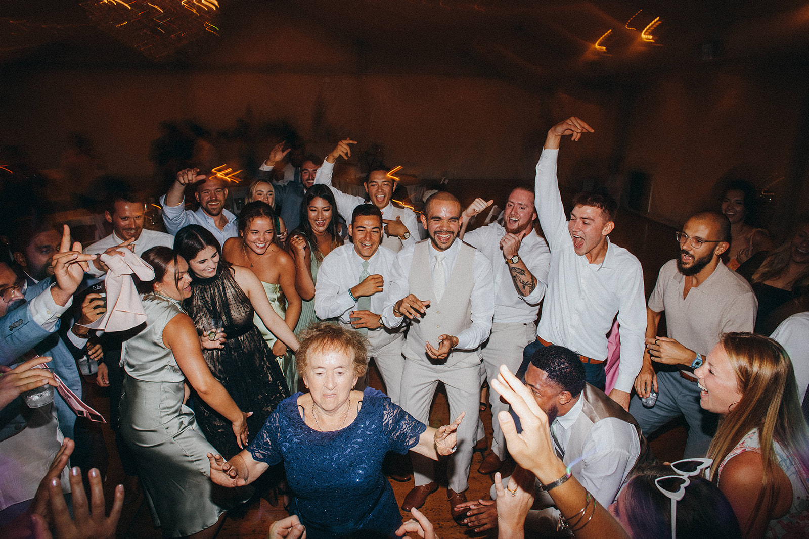 Amazing dancing photos of a grandma and the whole wedding party during a reception at Crosley Estate 