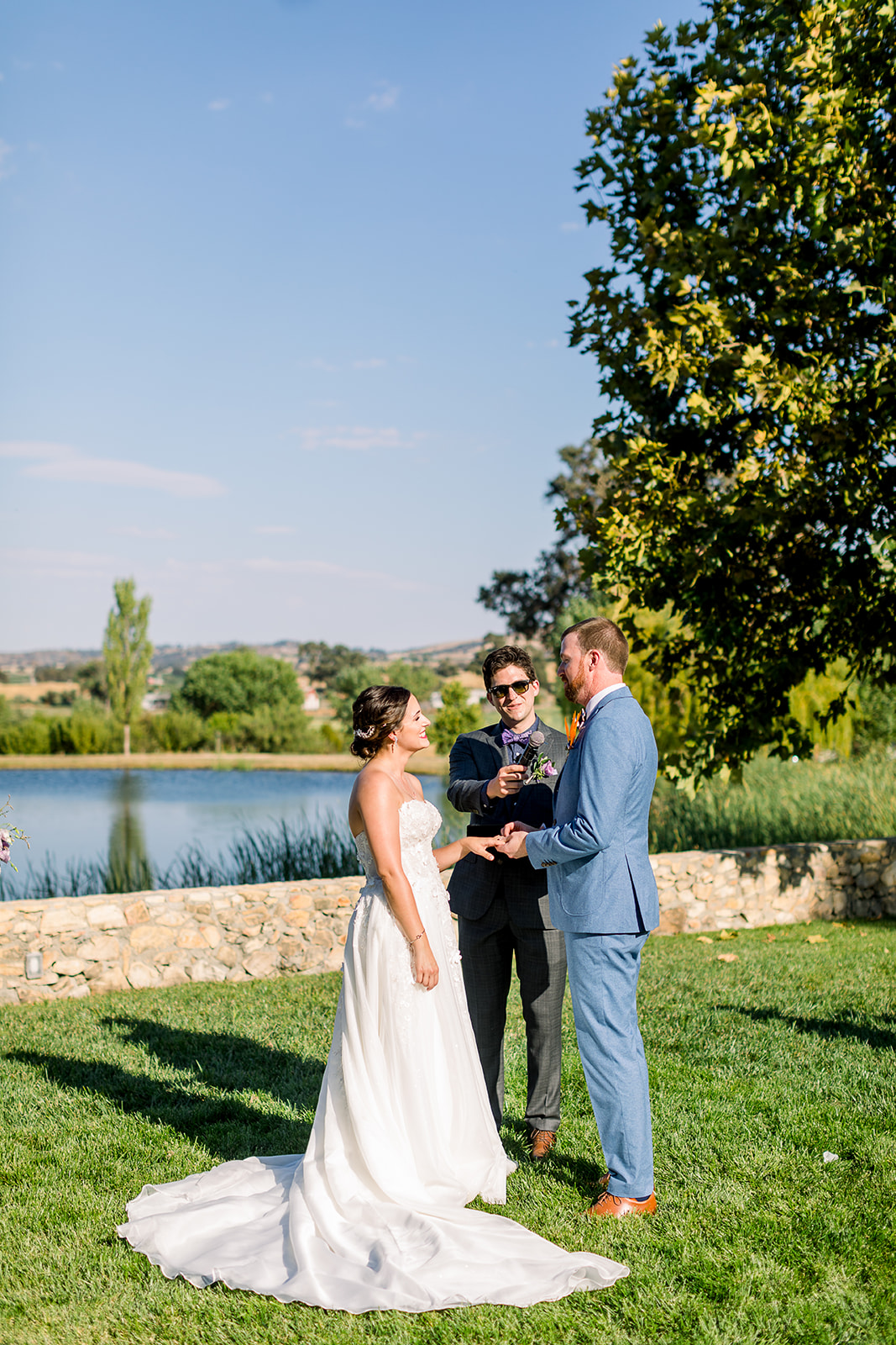 Bride and groom exchange vows by the tranquil pond at Willow and Oak Estate