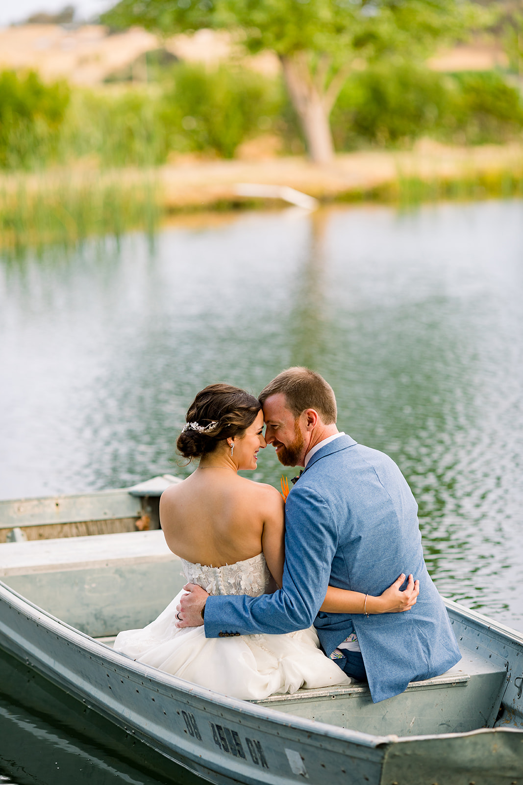 Bride and groom share a tender moment against the scenic beauty of Willow and Oak Estate