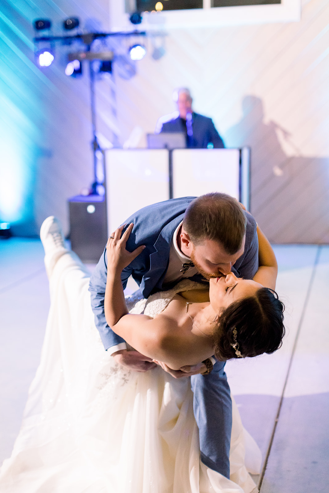 Bride's creamy train swirls as she joyfully dances with her groom at Willow and Oak.