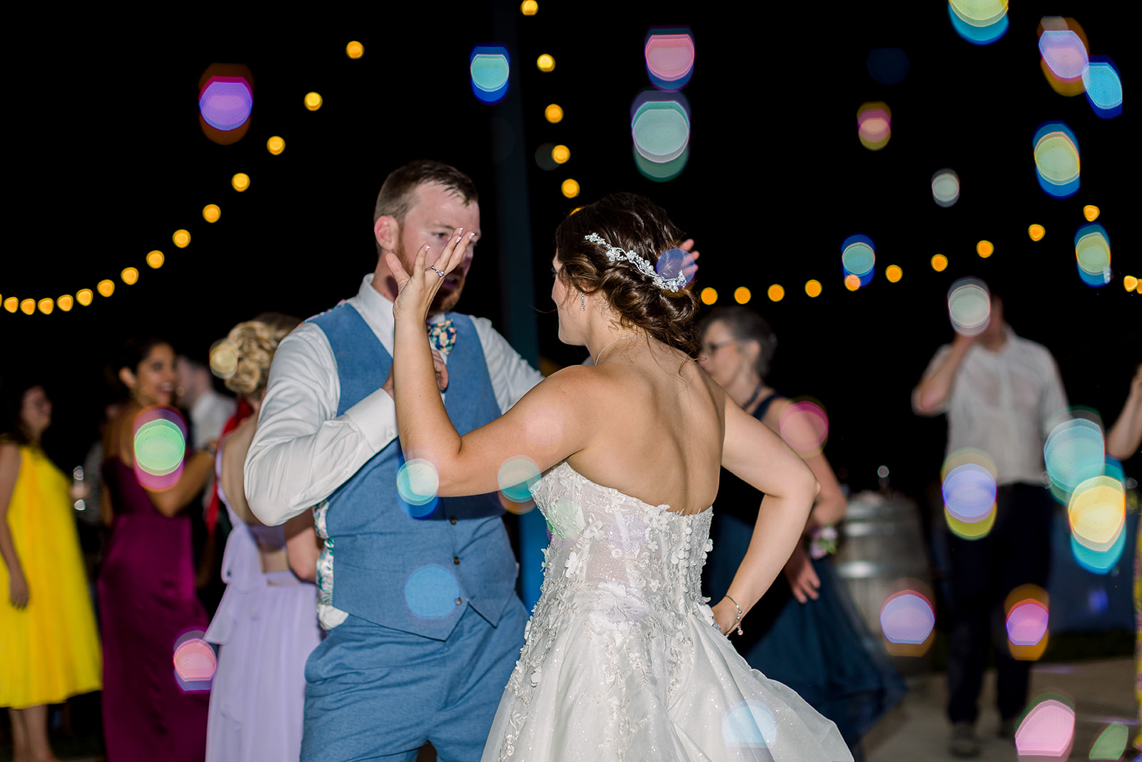 Groom spins the bride with genuine happiness, capturing the essence of their celebration