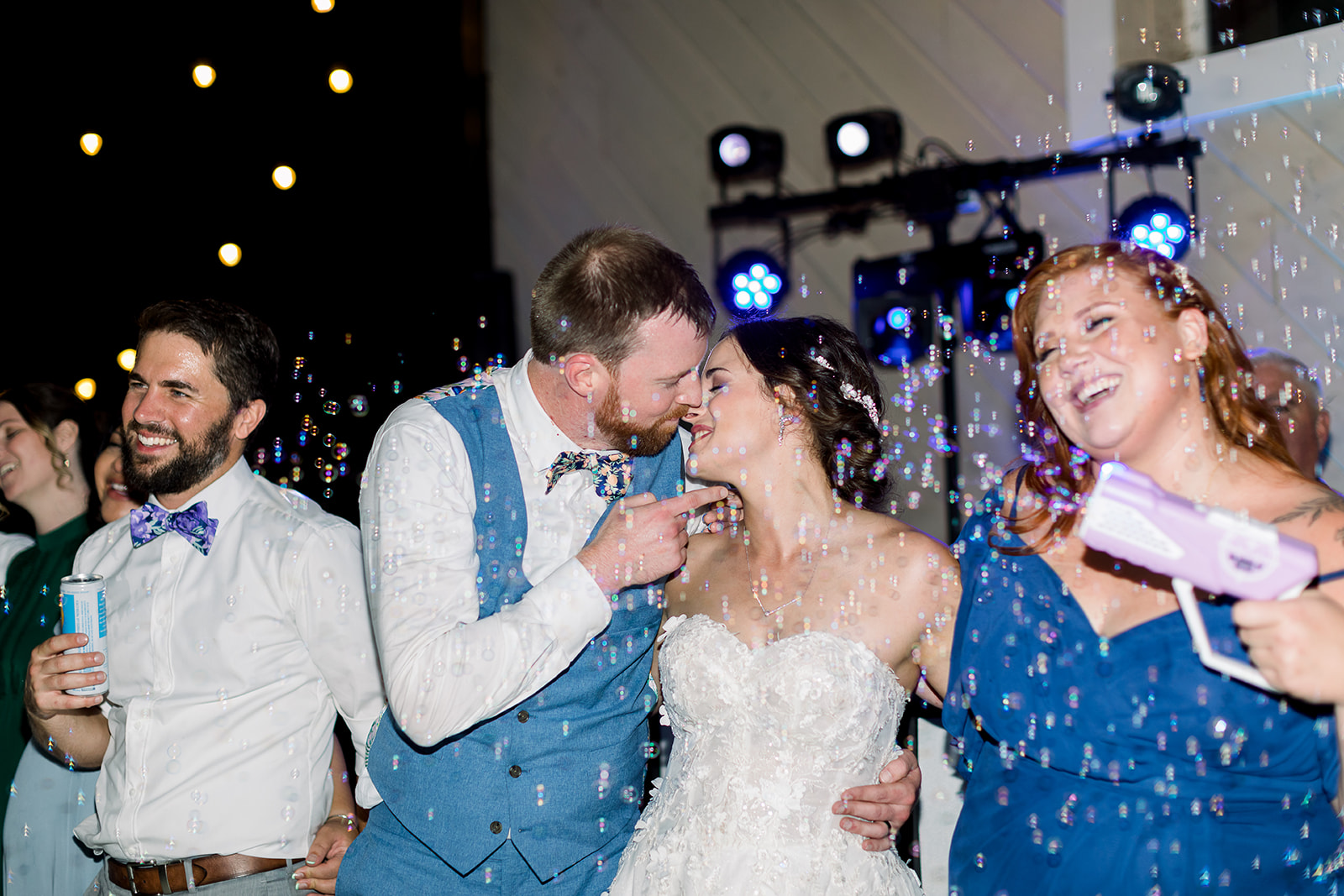 Lifelong friends surround the couple, creating a heartwarming circle of camaraderie on the dance floor