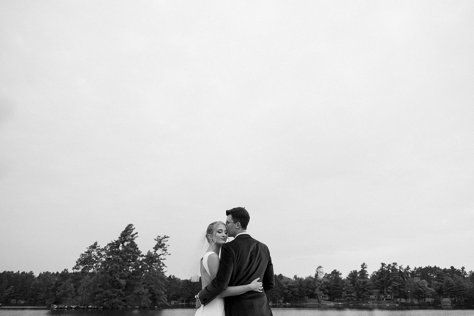 bride and groom embrace during their wedding day portraits at chippewa retreat resort