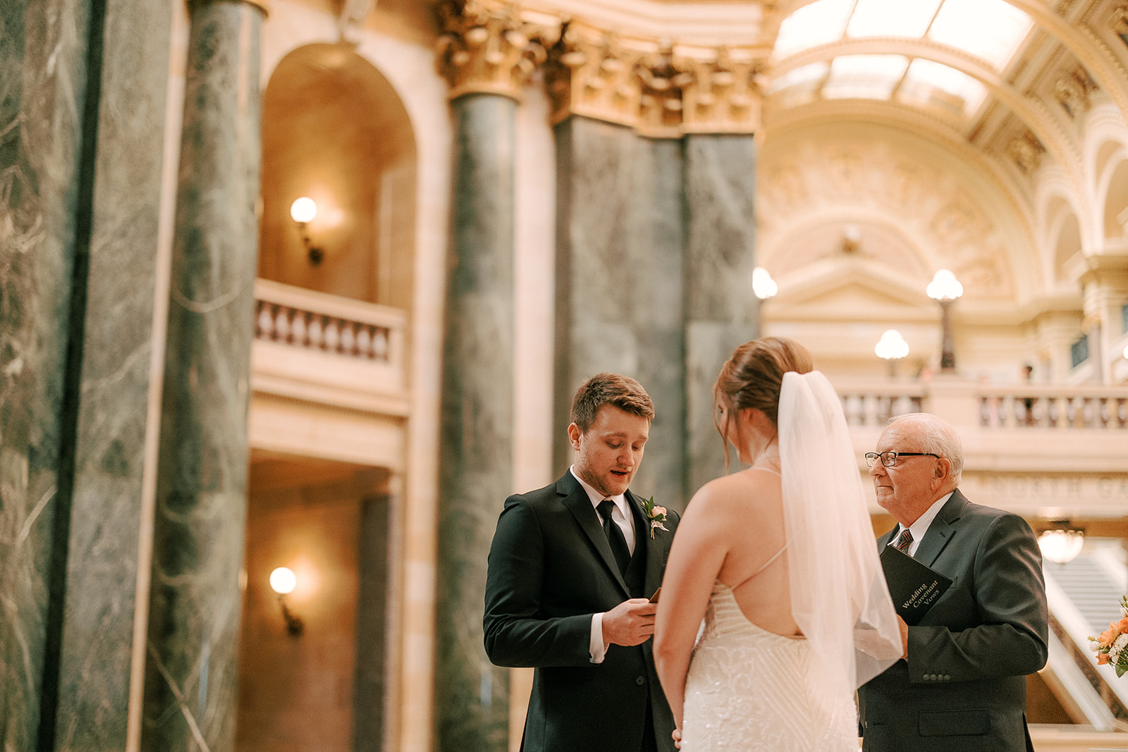 bride and groom have intimate ceremony on their elopement day at the wisconsin state capitol