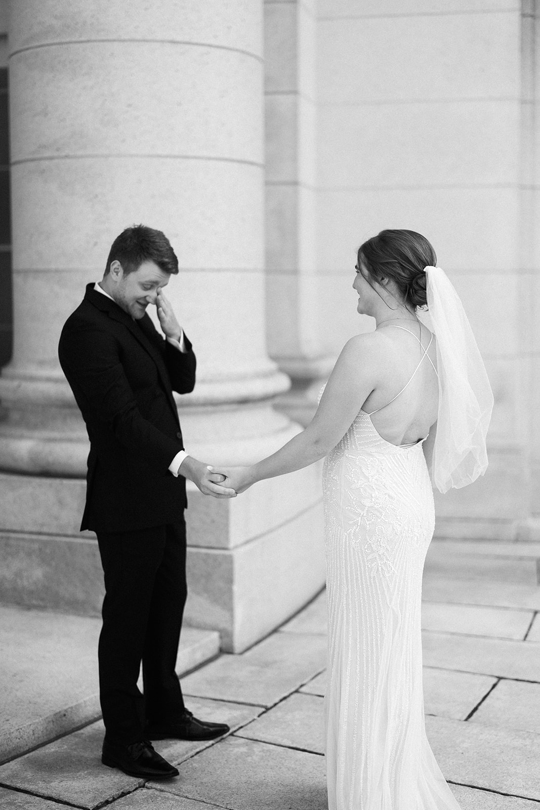 bride and groom share a first look on their wedding day at the wisconsin state capitol building