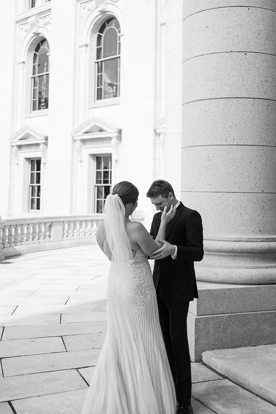 bride and groom share a first look on their wedding day at the wisconsin state capitol building
