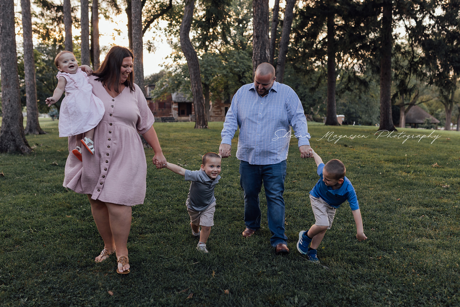 Outdoor family session near Naperville, IL with a dad, mom, two sons and one year old daughter at an old estate.