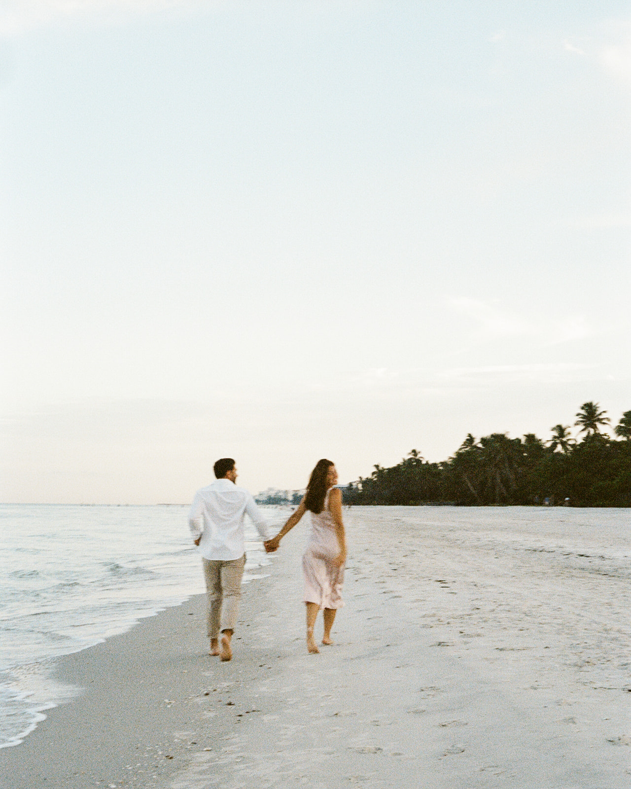 a couple walking on naples beach florida