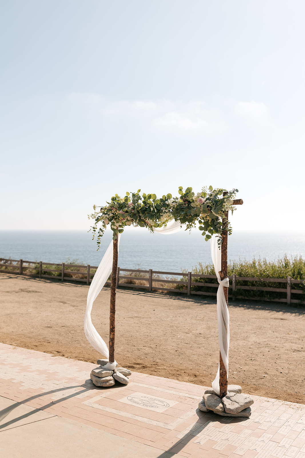 point vicente lighthouse wedding rancho palos verdes california wooden arch summer white green florals roses