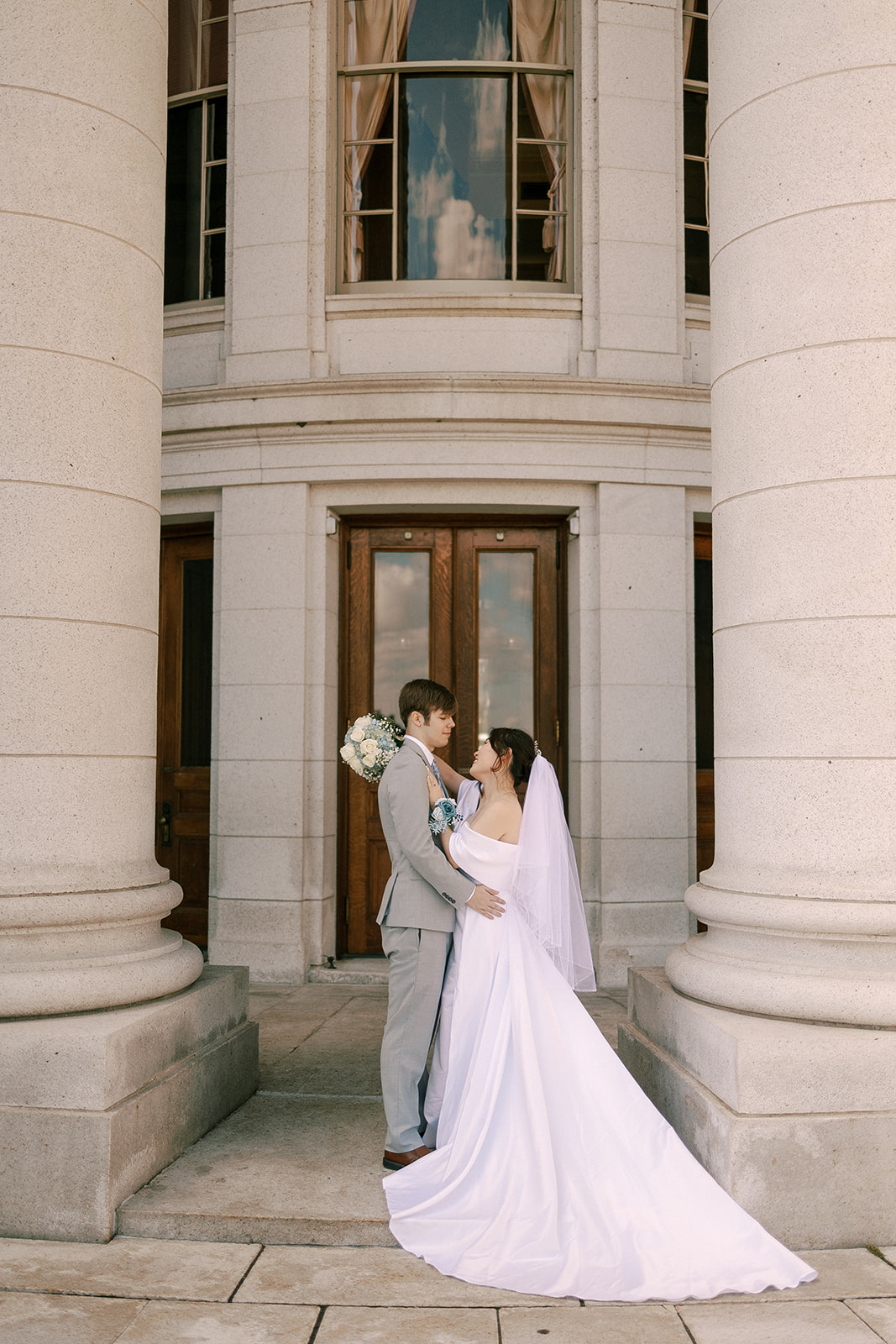 bride and groom embrace on their elopement day at the wisconsin state capitol