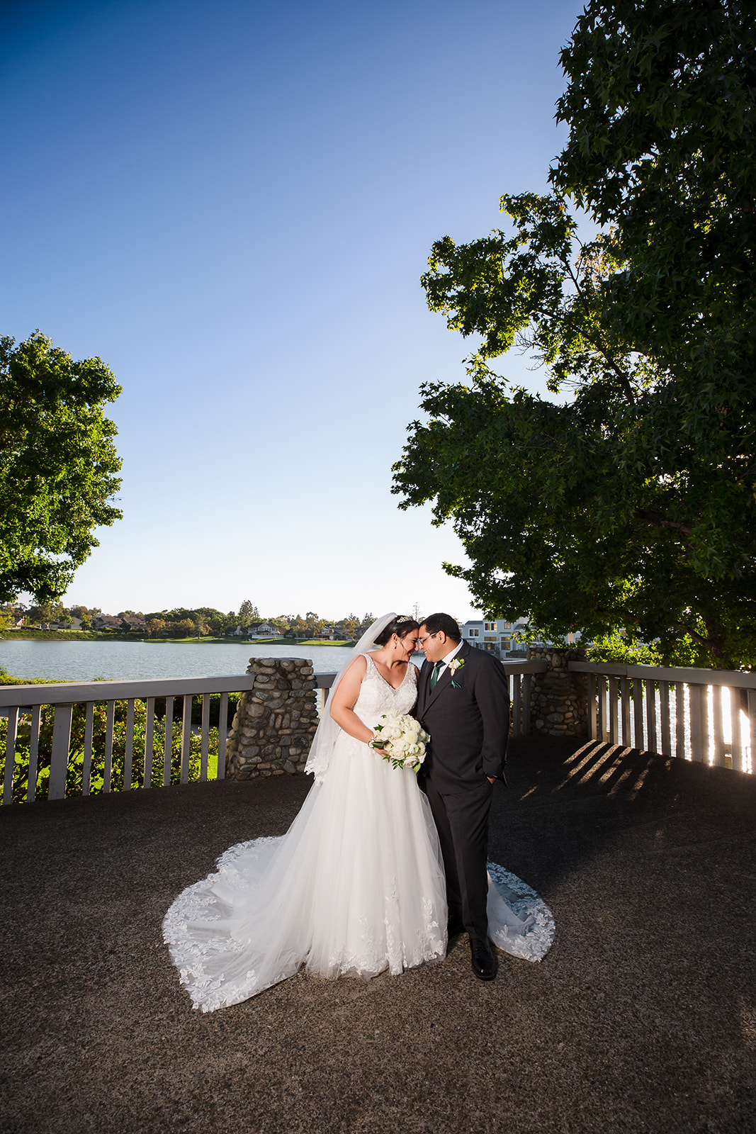 Bride and groom wedding portrait overlooking a lake in Irvine, CA