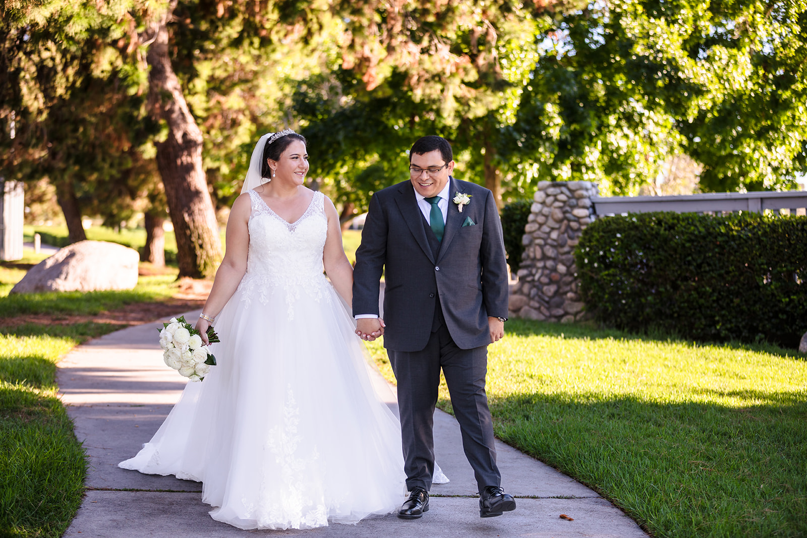 Bride and groom walking portrait in a park, Irvine, CA