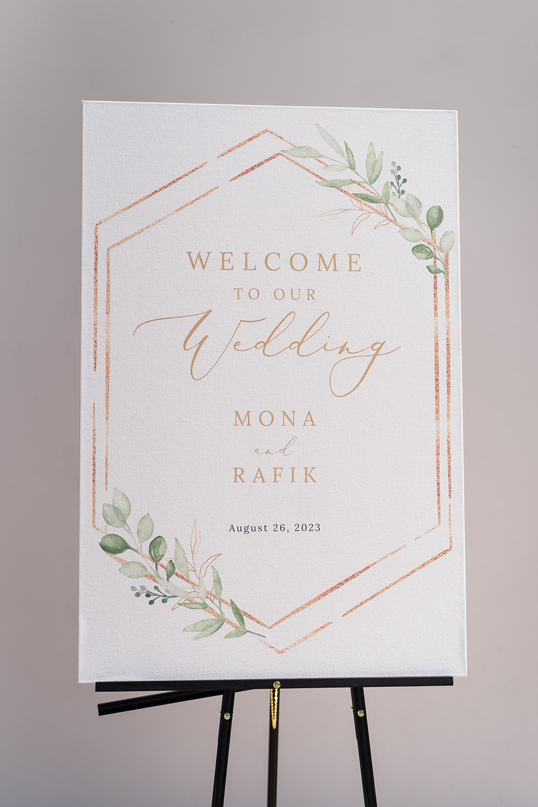 White and gold wedding sign with green leaves 