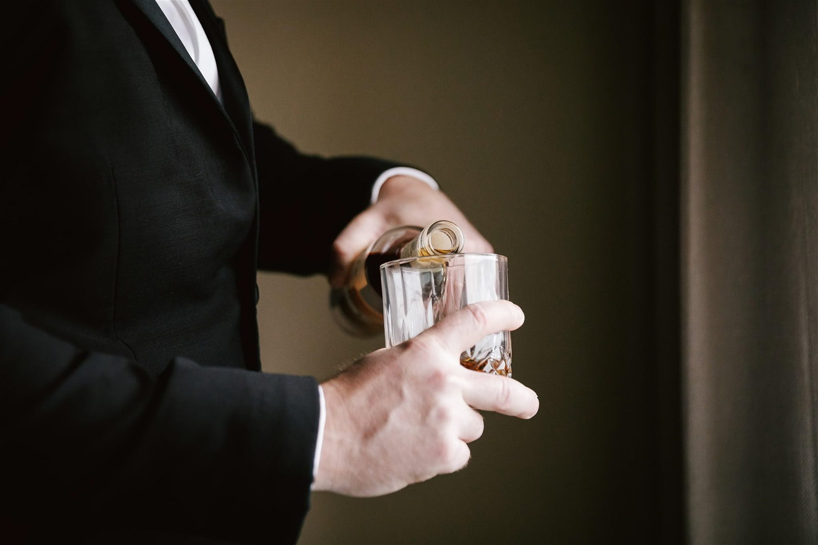 Groom's getting ready includes a classic whiskey toast, setting the tone for a day filled with celebration.