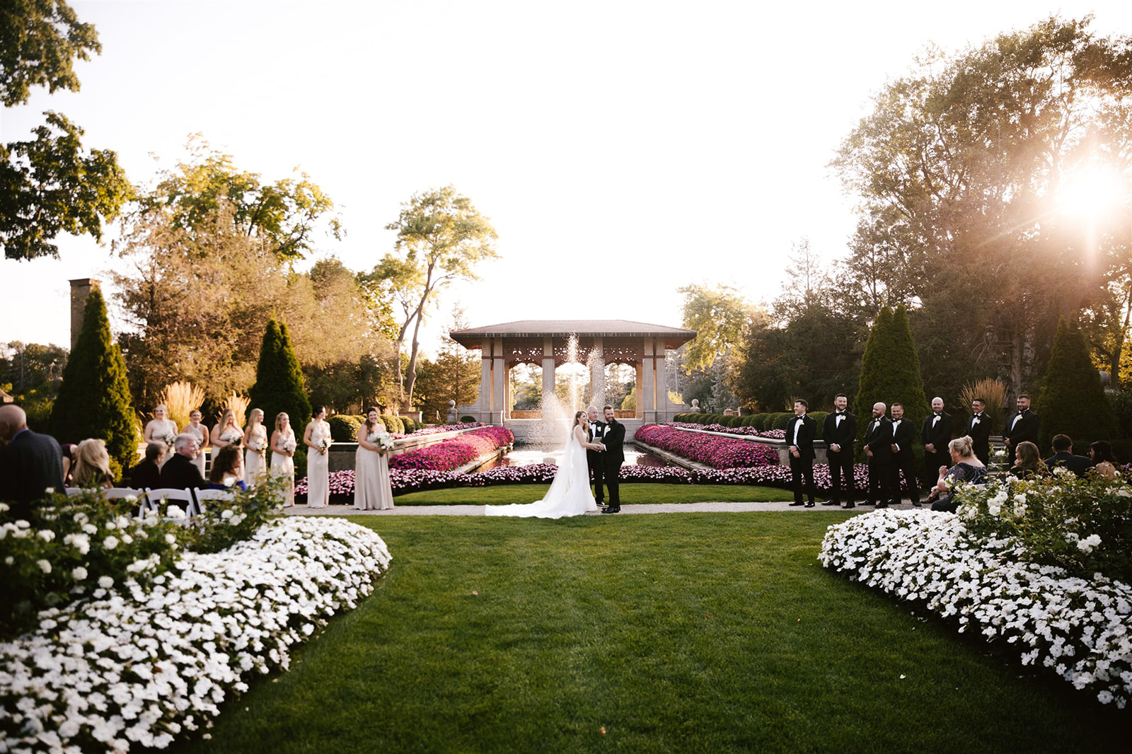 As the sun sets over Armour House, casting a golden glow, the ceremony takes on a magical and romantic ambiance.