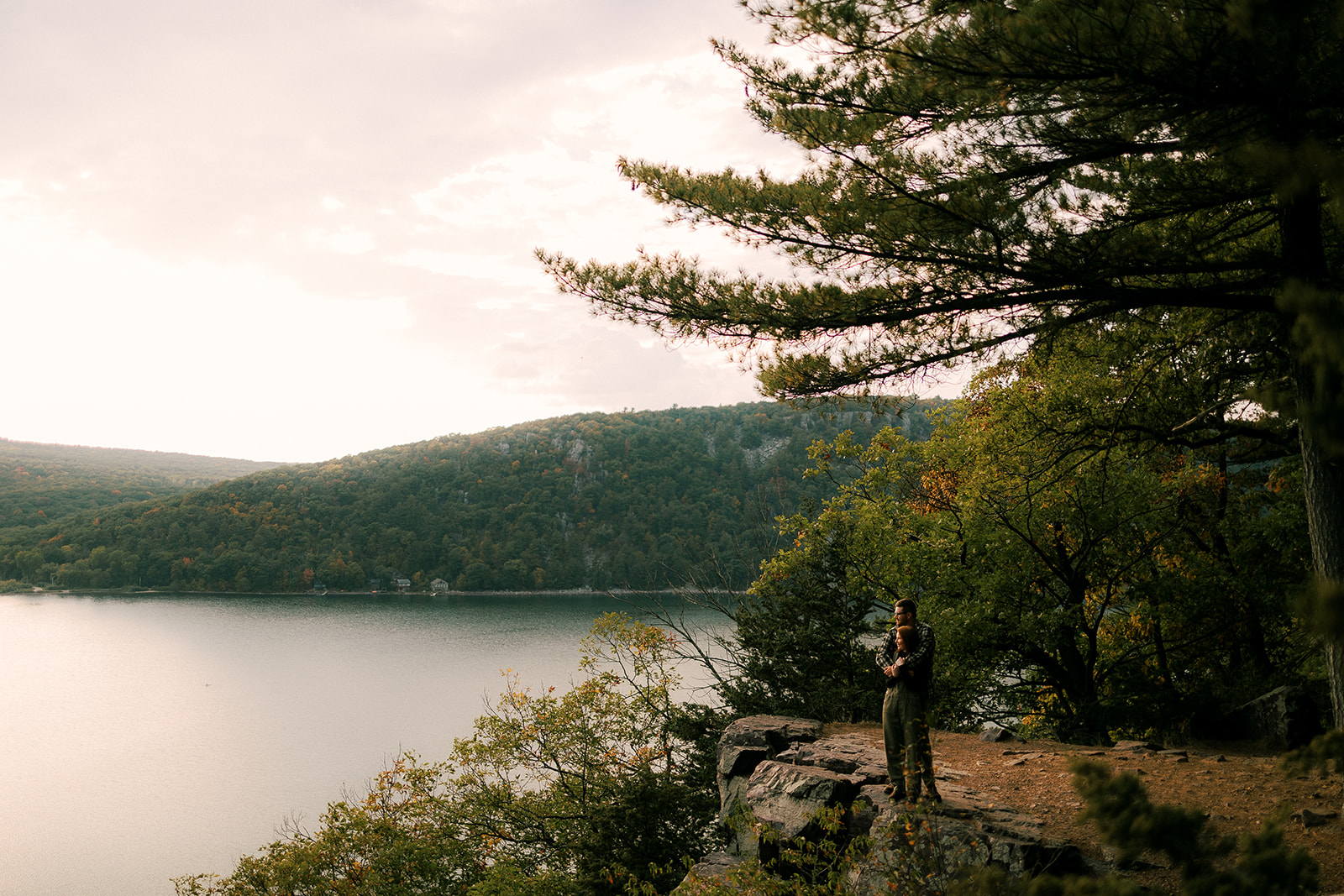 couple holds each other as they look out onto Devil's Lake State Park in Baraboo, Wisconsin.