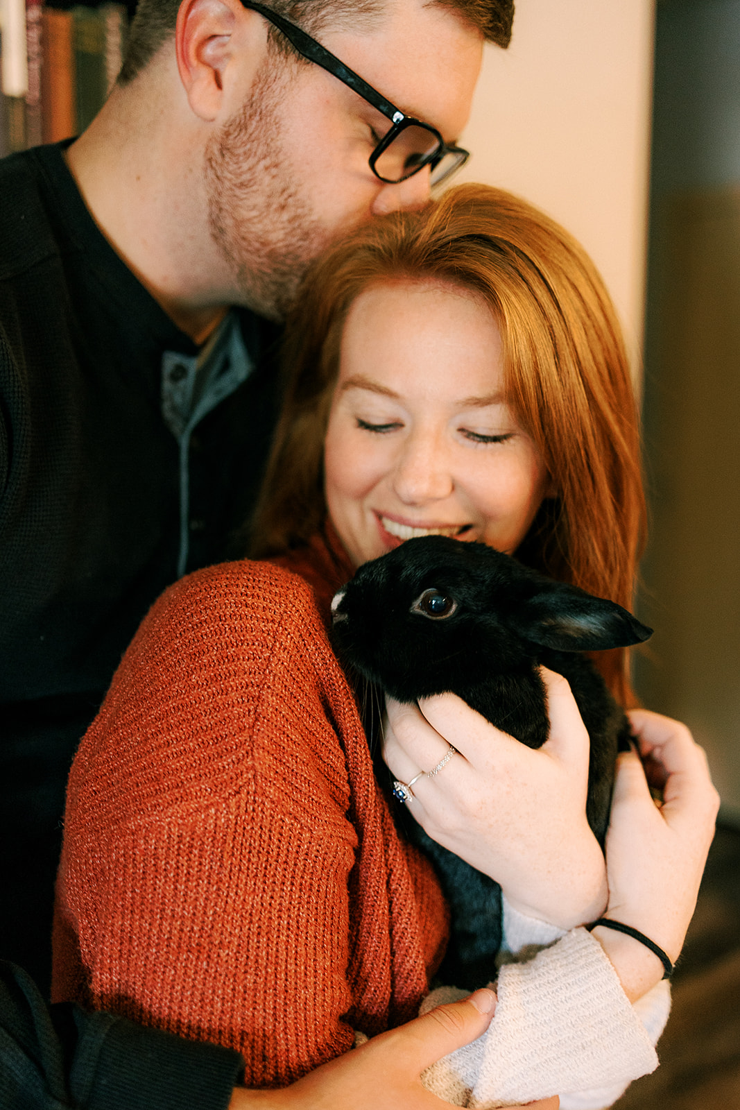 couple holds their rabbit during their engagement photos in madison, wisconsin