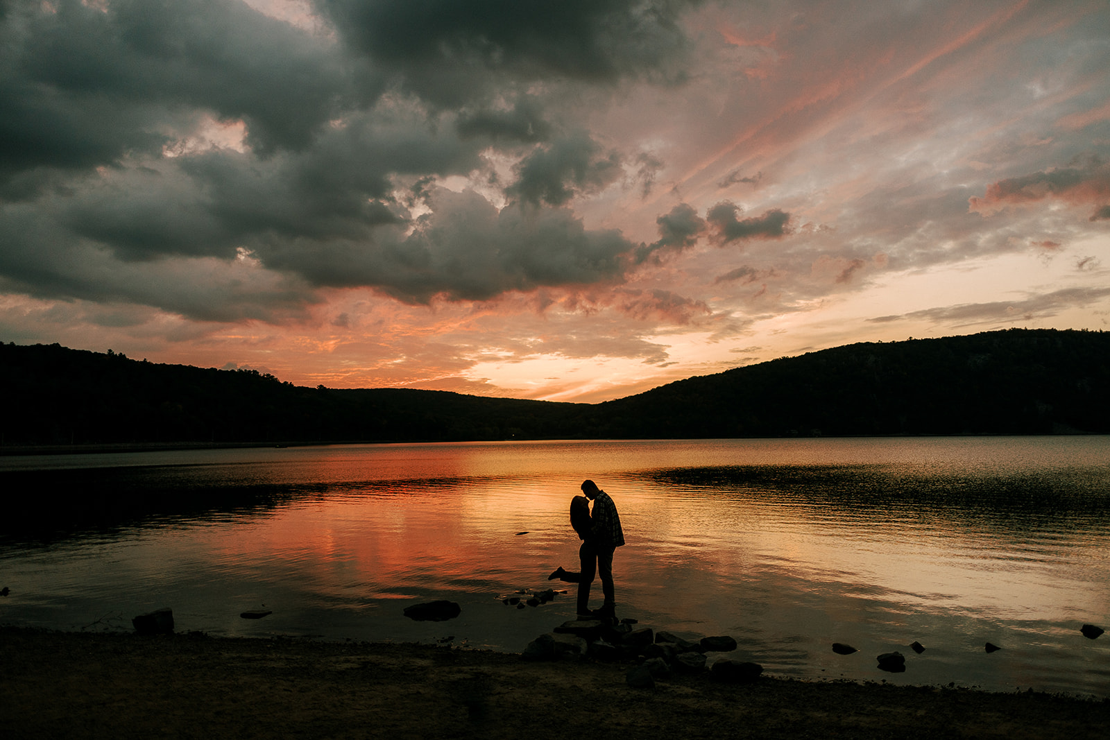 Couple kisses at sunset at Devil's Lake State Park during their engagement session