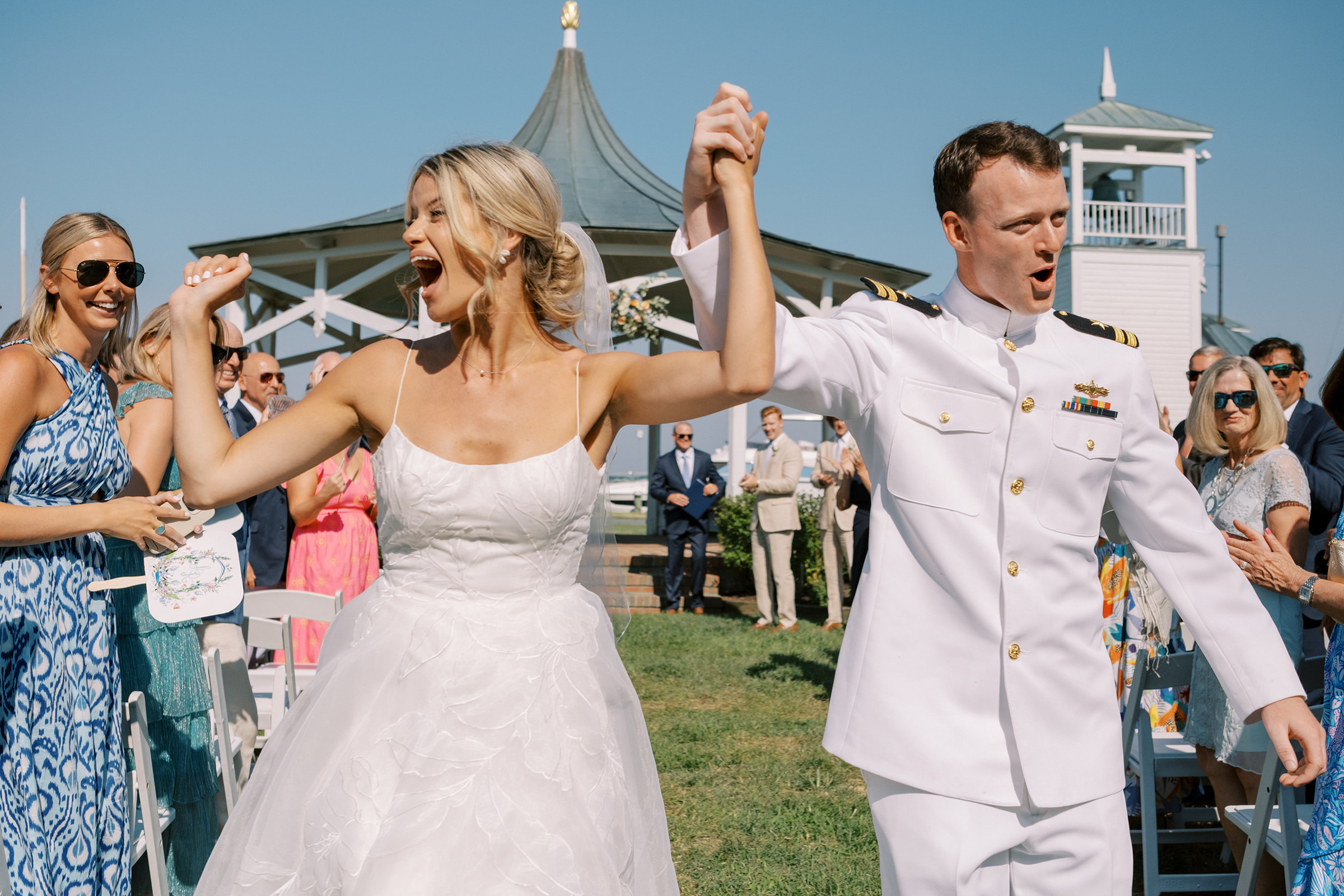 Bride and groom celebrate walking back up the aisle in Saint Michaels wedding