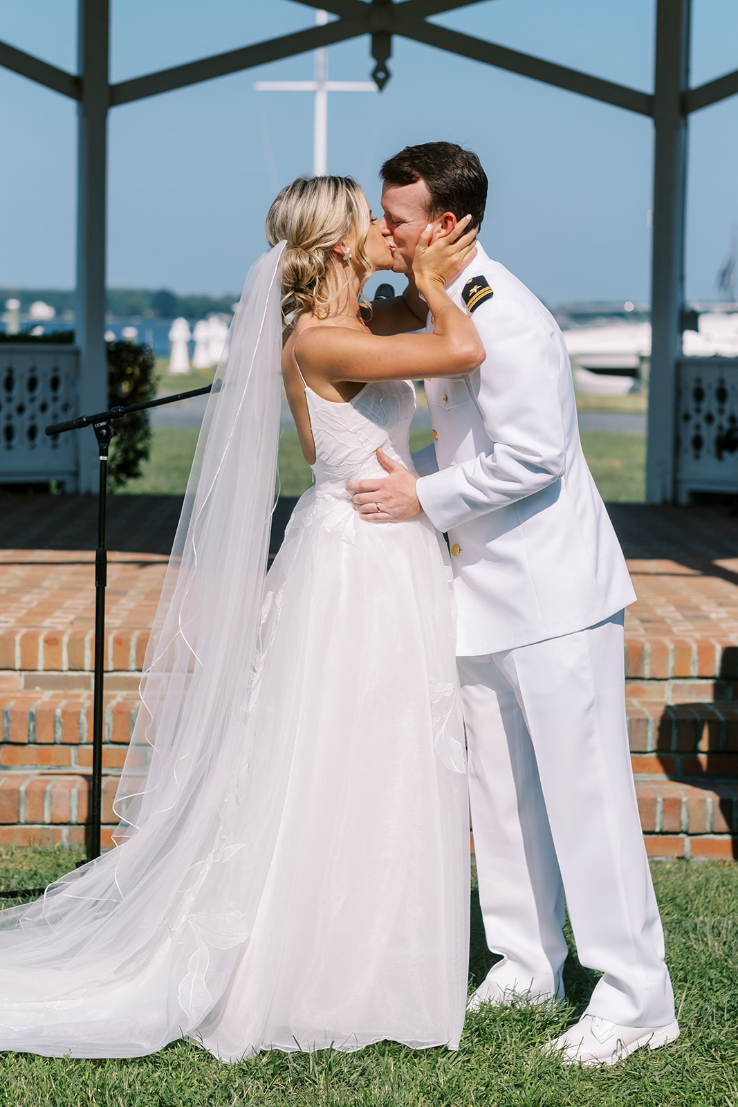 bride and groom kiss at chesapeake bay maritime museum wedding in front of the gazebo