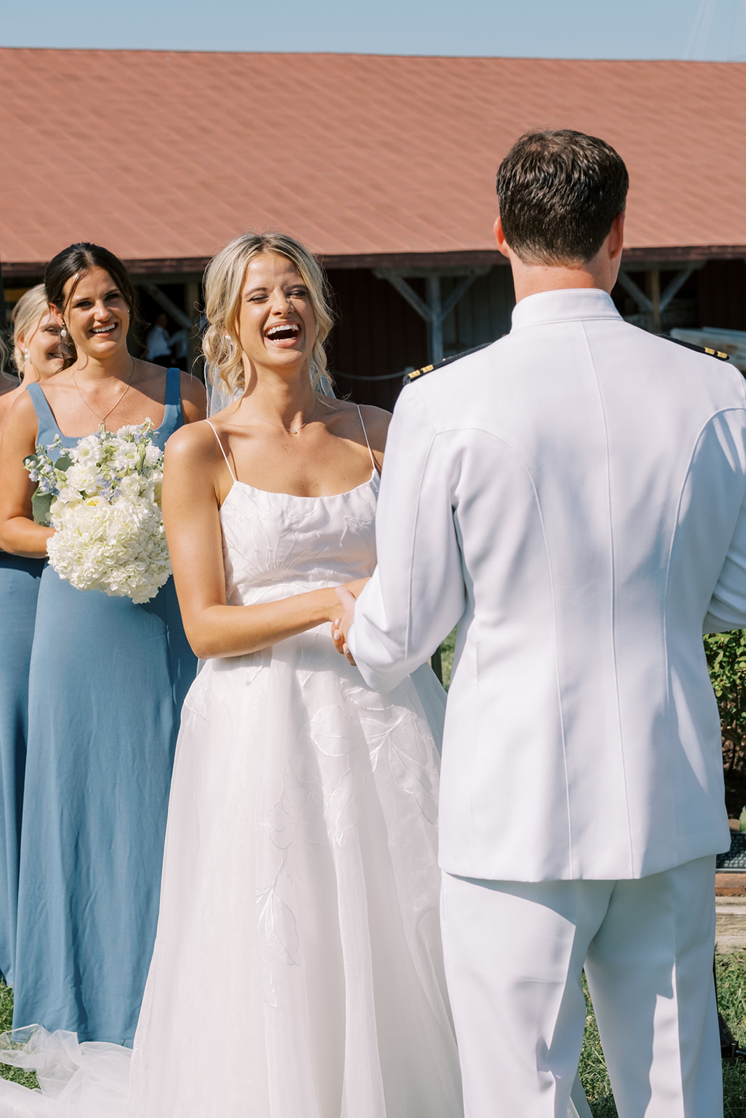 bride laughs during wedding ceremony vows at chesapeake bay maritime museum