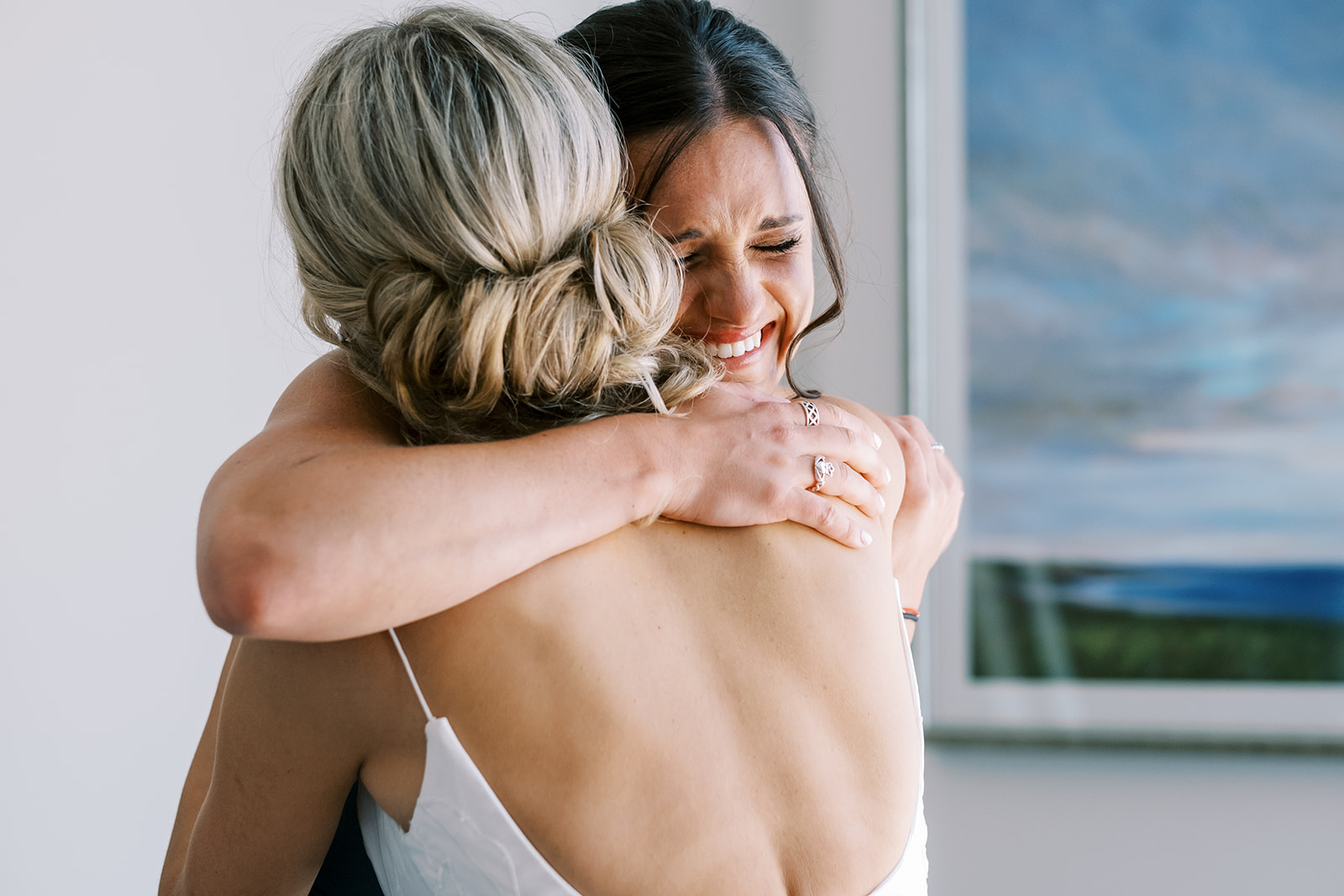 bride and sister embrace during getting ready at harbour inn in saint michaels