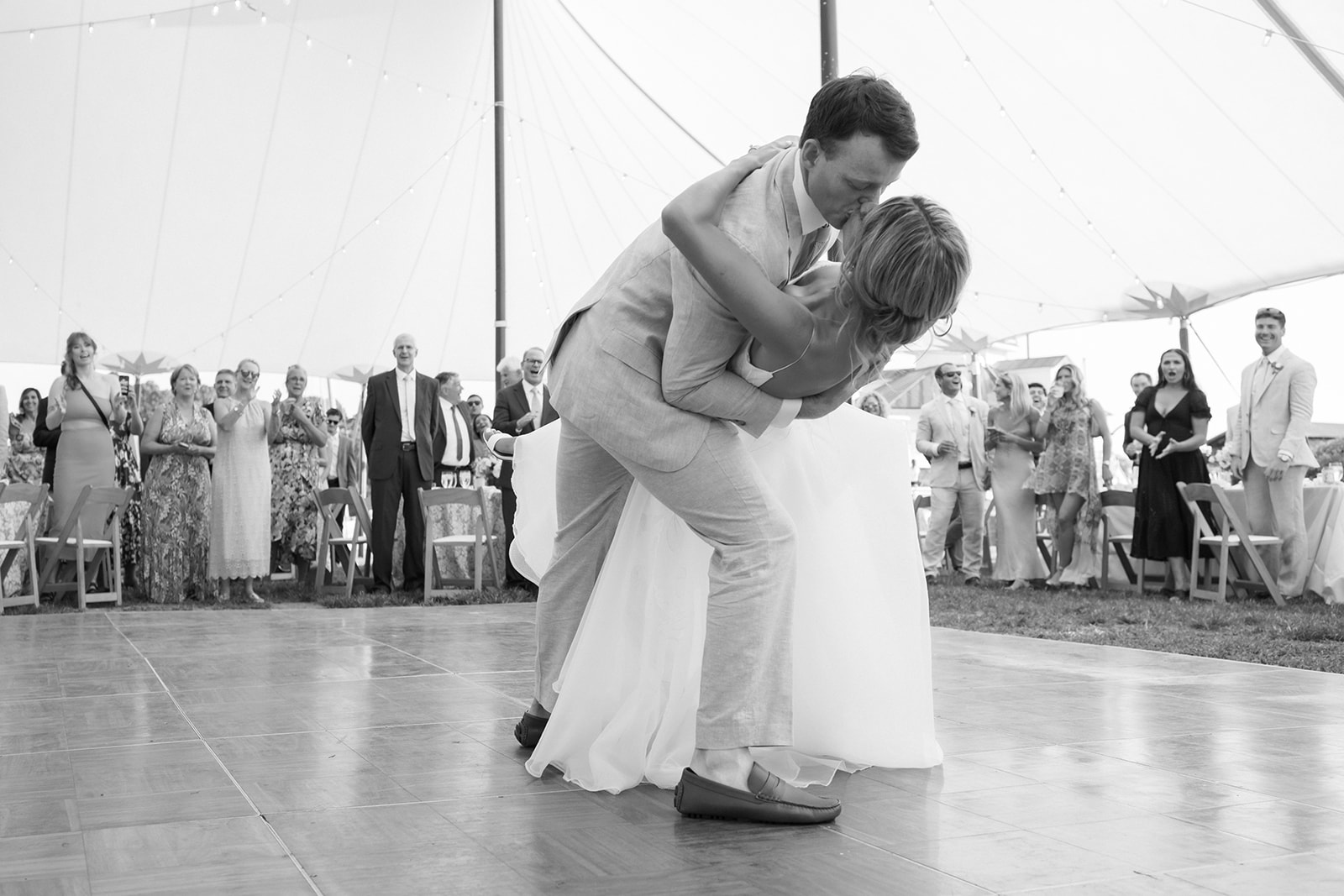 groom dips bride during first dance at saint michaels chesapeake bay martime museum wedding