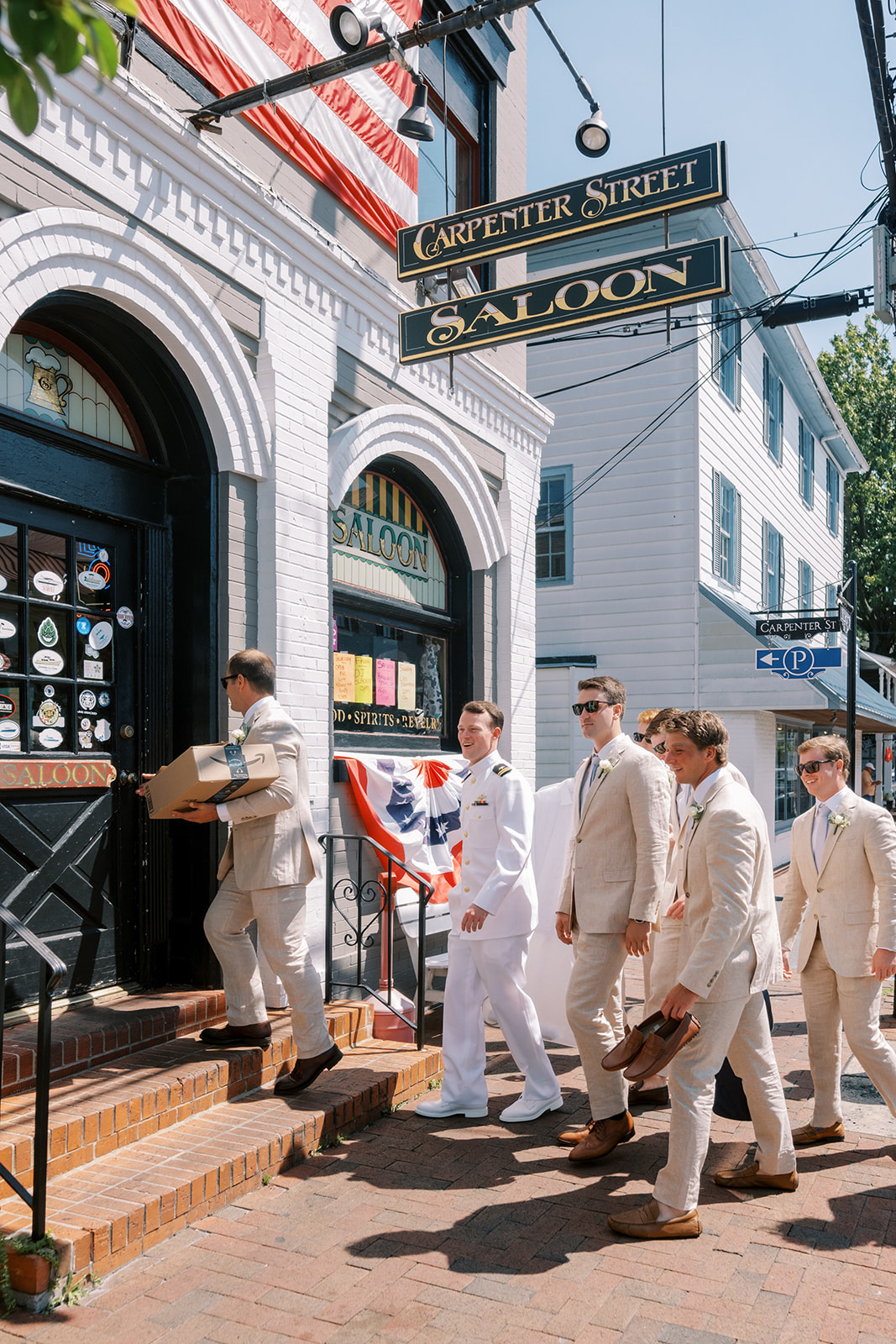 groomsmen walk into a bar in saint michaels for a drink before the wedding