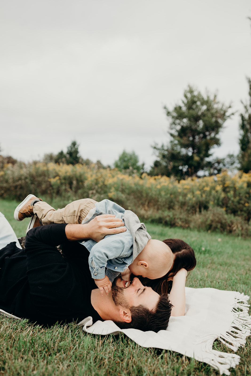 Family snuggles at a picnic during their family photoshoot