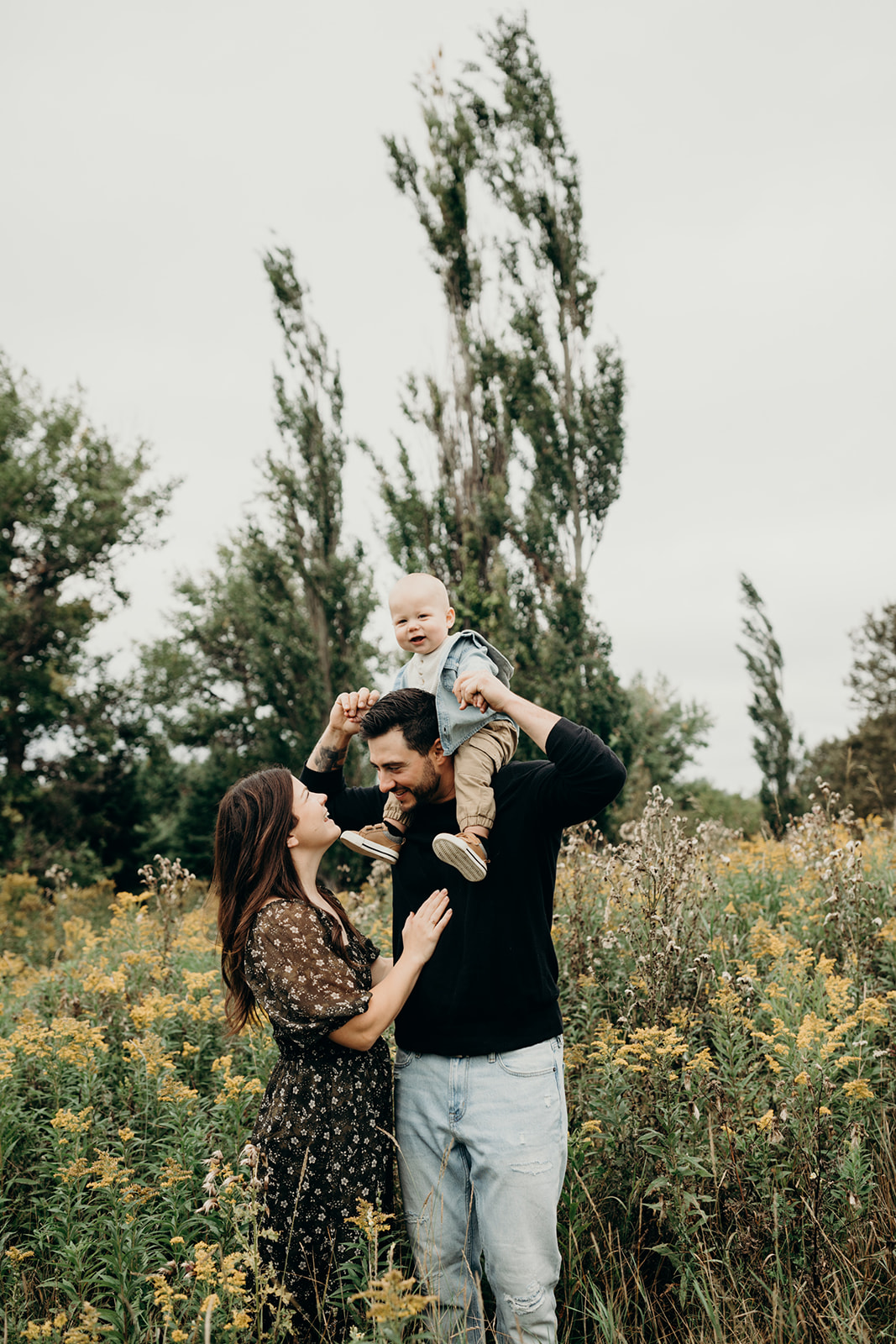 Mom and Dad pose with small child during family photoshoot