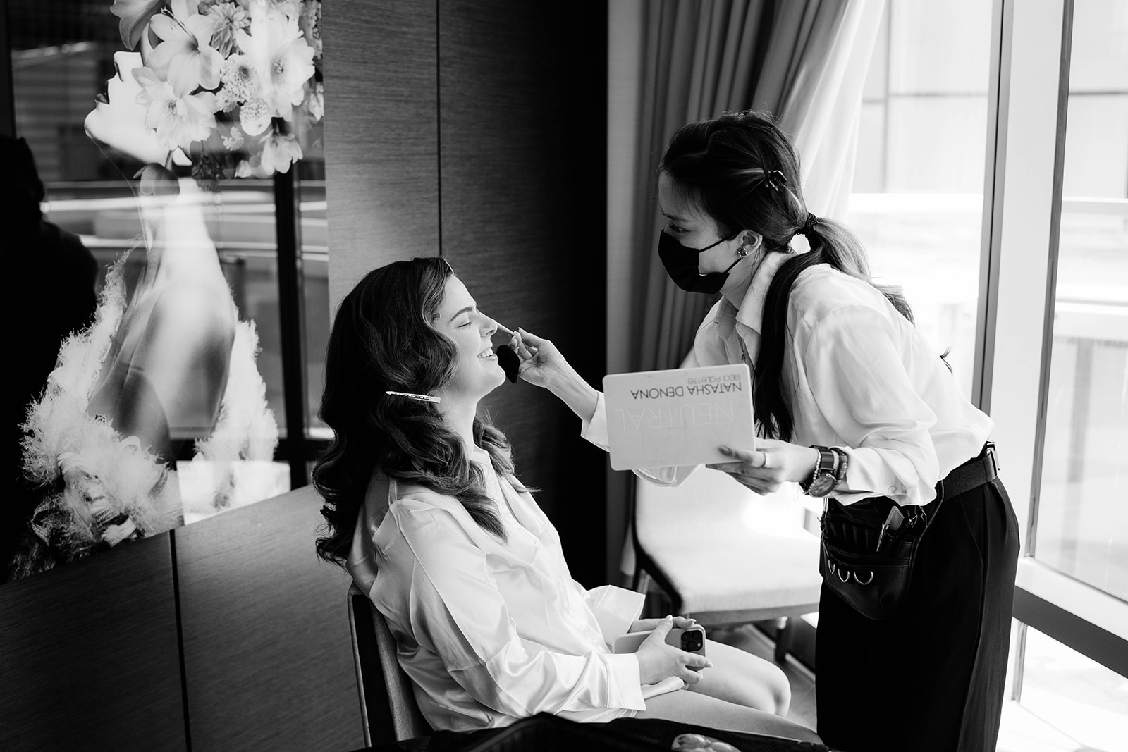 bride getting her makeup done at hotel