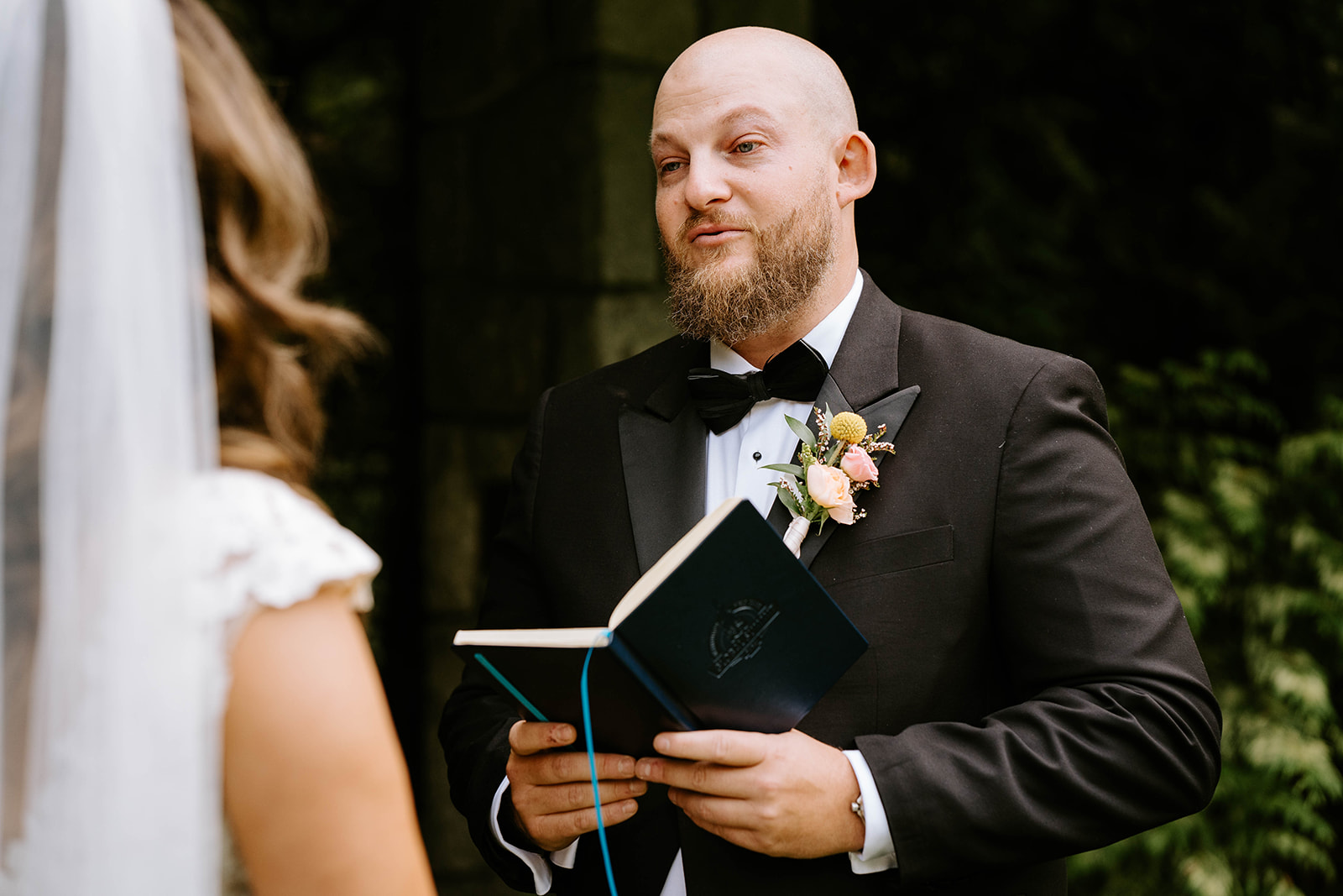 groom reading his vows during ceremony