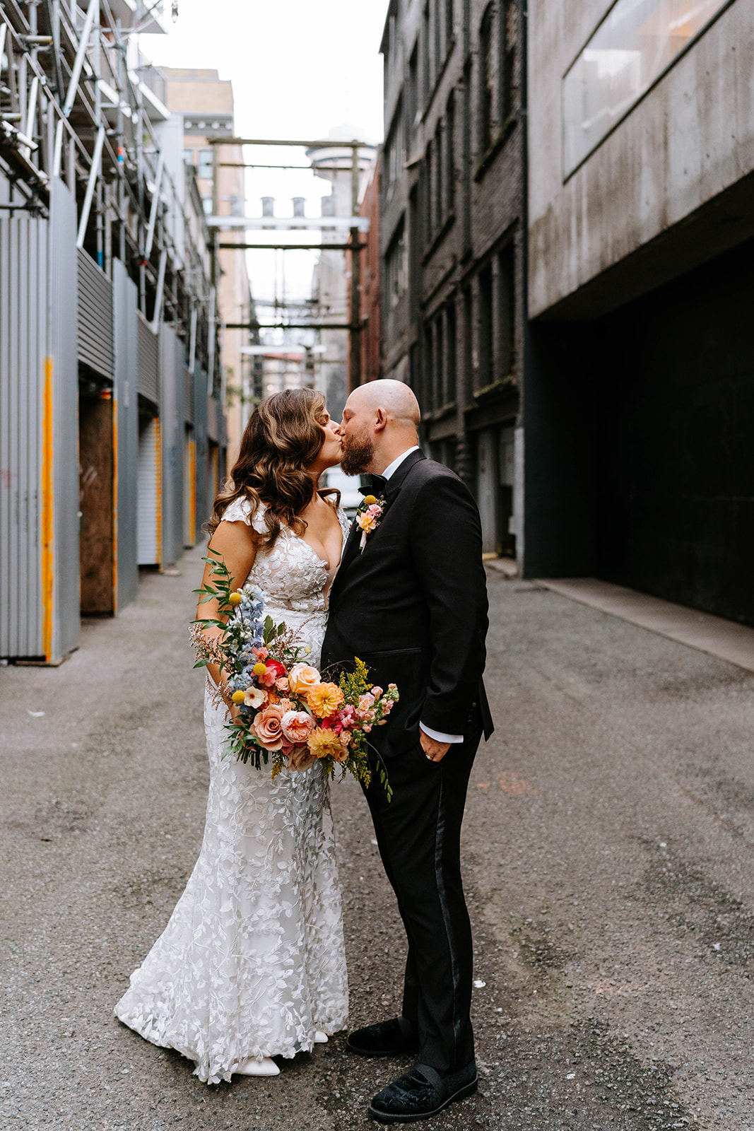 bride and groom walking down Gastown alley in vancouver