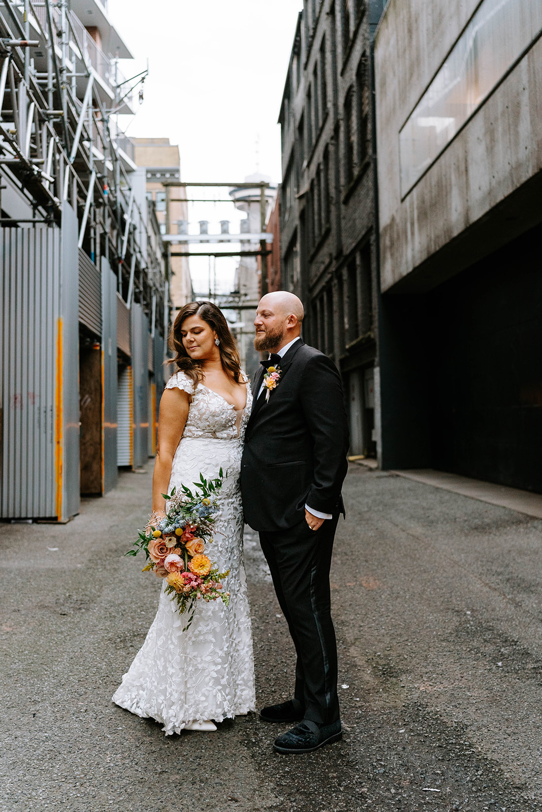 bride and groom walking down Gastown alley in vancouver