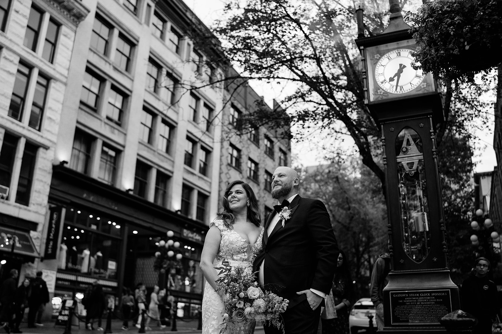 bride and groom by the Gastown Steam Clock in Vancouver