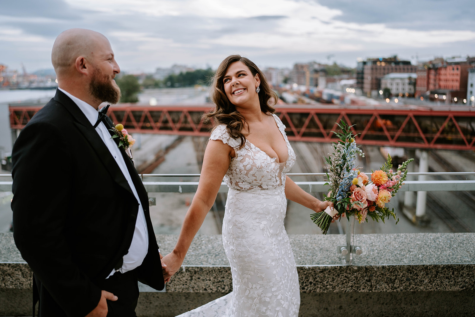 bride and groom by railroad tracks in downtown Vancouver