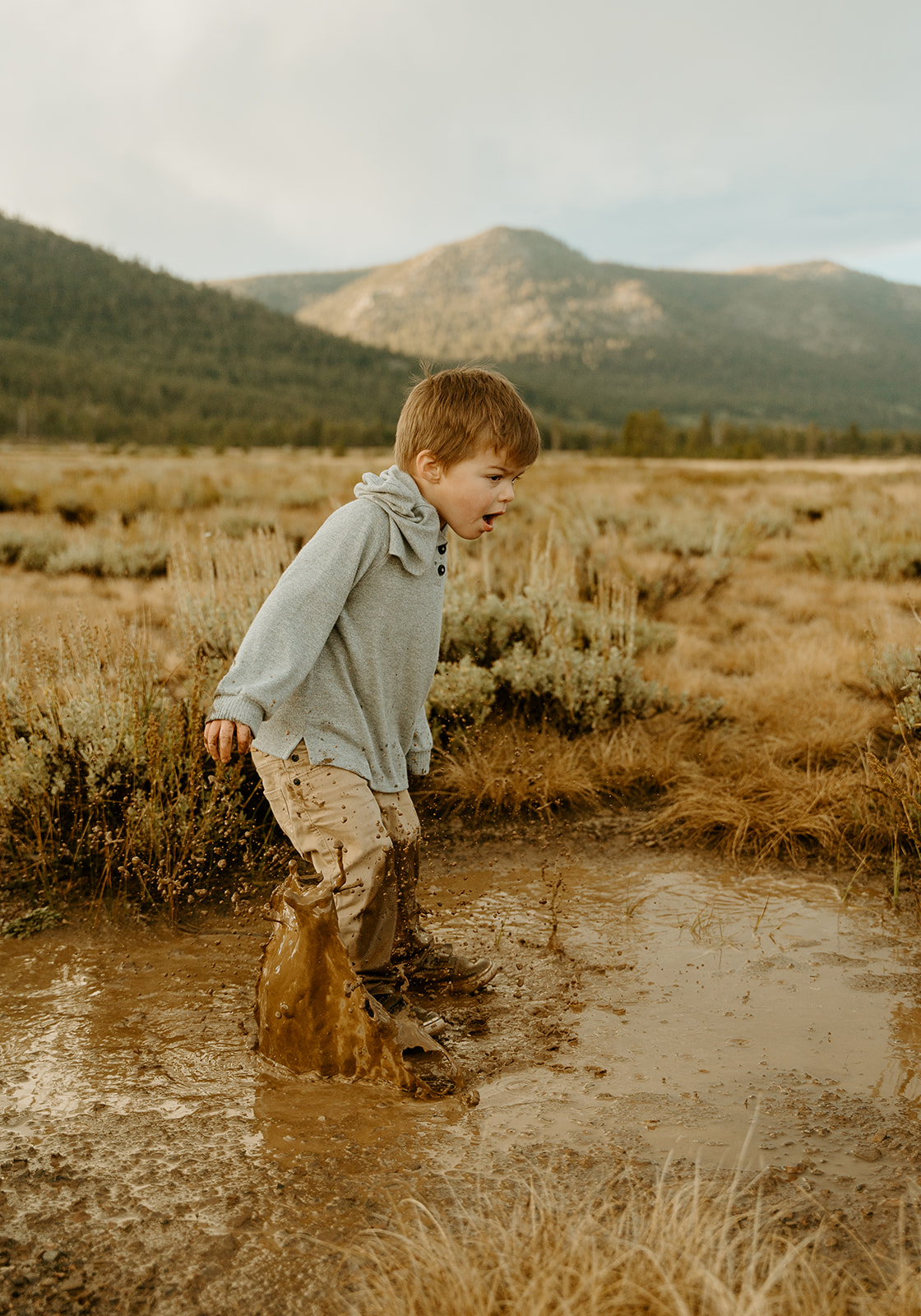 letting boys be boys during our family photoshoot while stomping in the mud for fun family photos.
