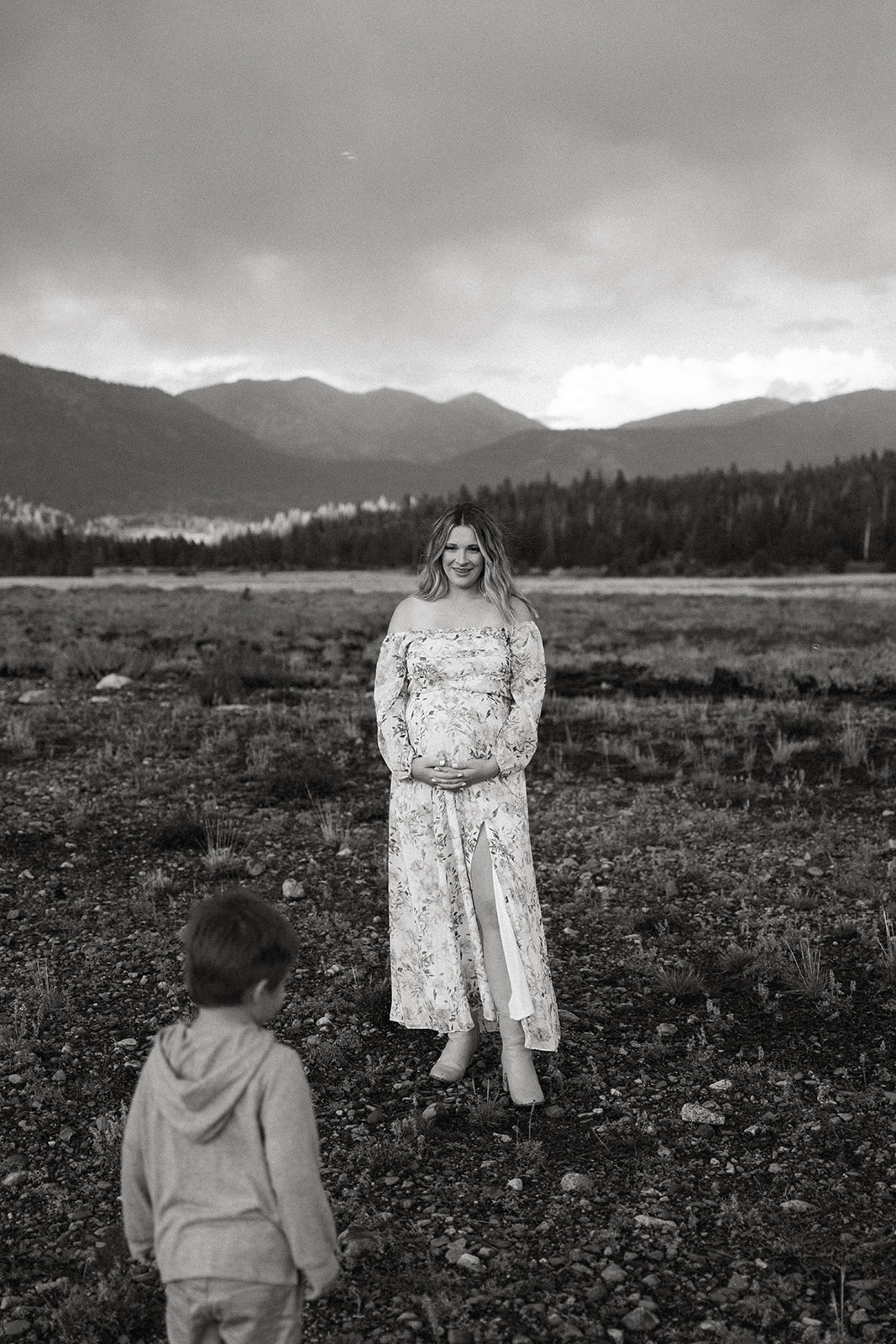 this black and white image of a son gazing at his mother during her maternity photos is beyond precious.