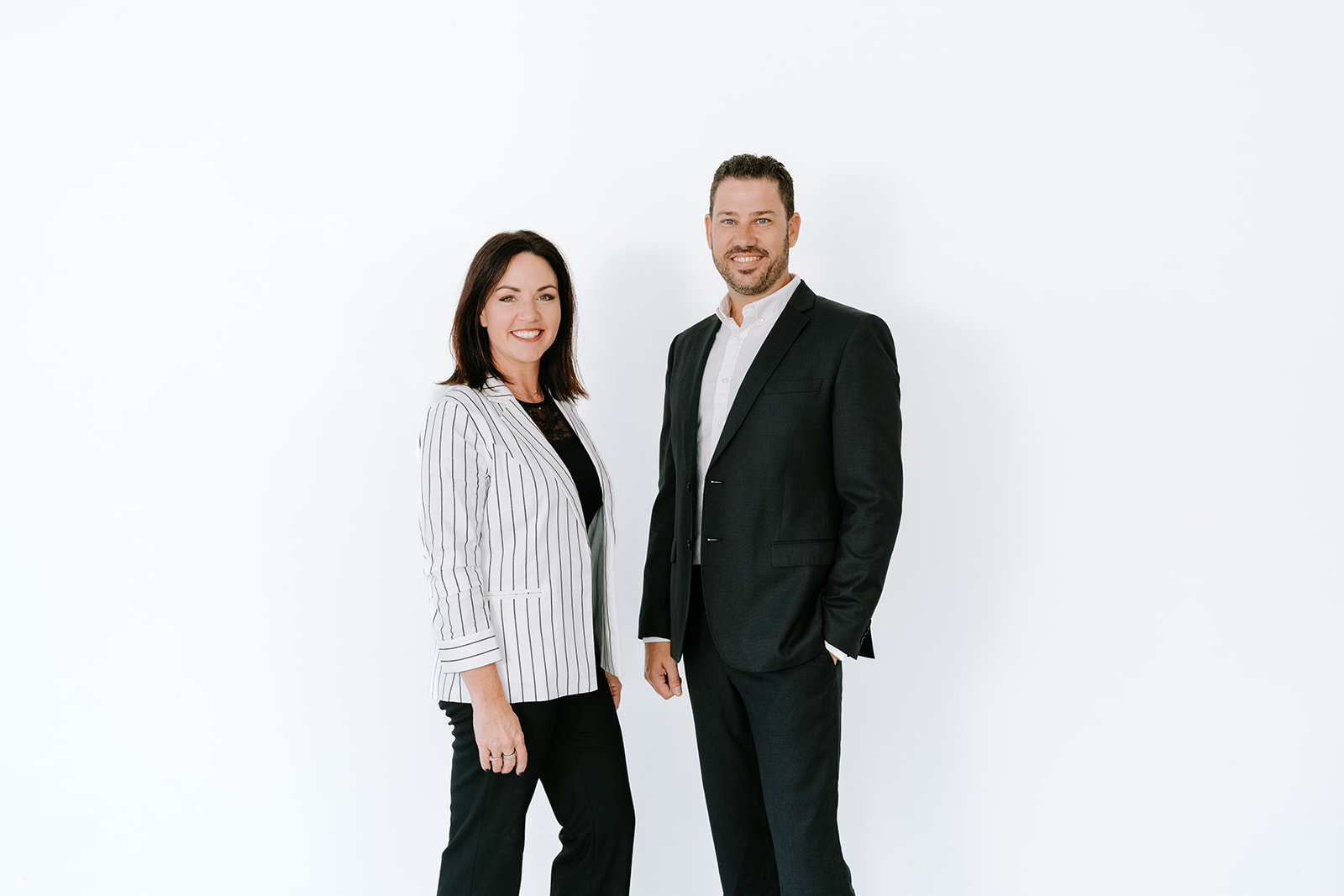 male and female real estate agents in black and white outfits