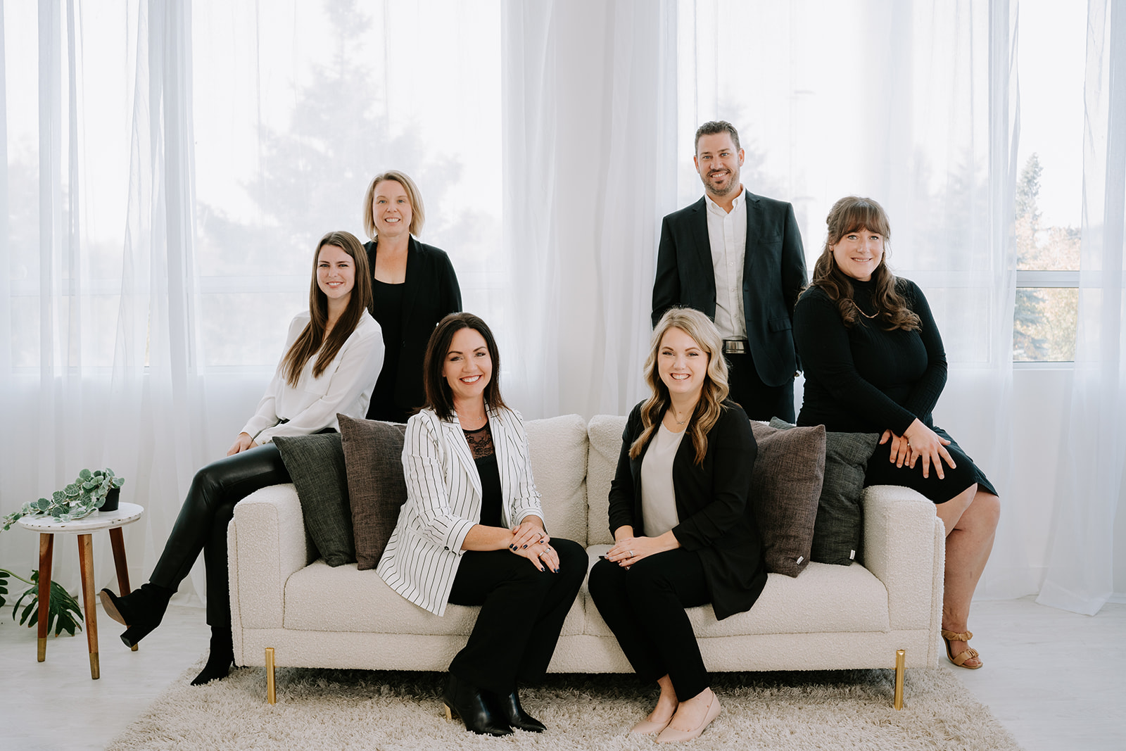 real estate team sitting on a white couch