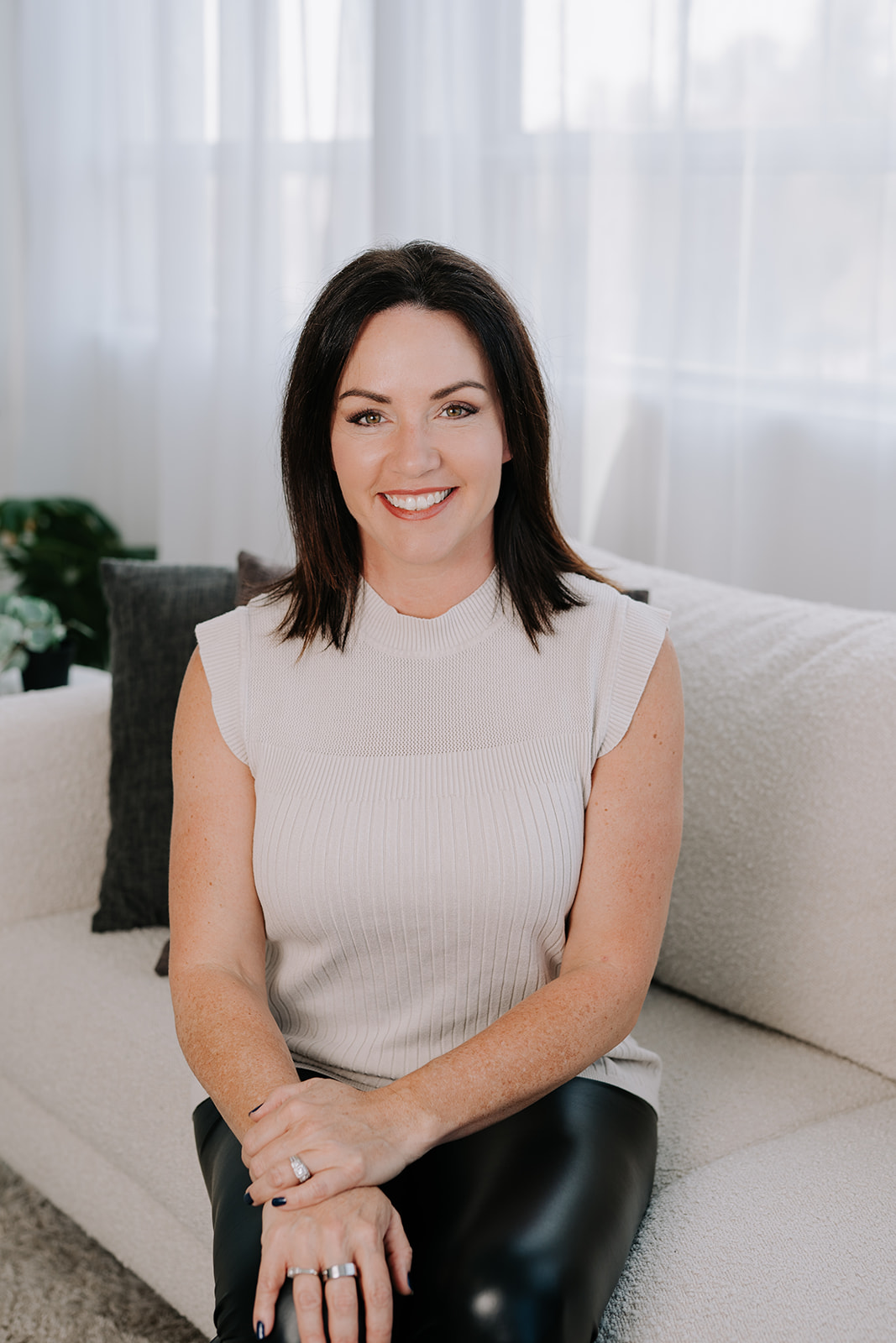 female real estate agent sitting on a couch
