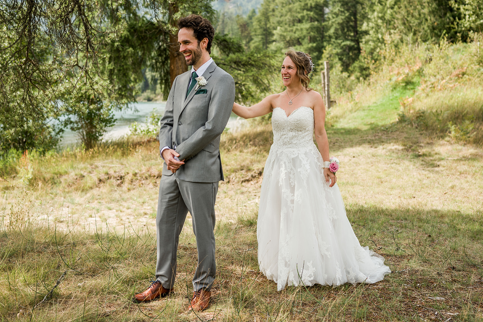 a couple's first look by the water at kootenay corner gardens wedding venue