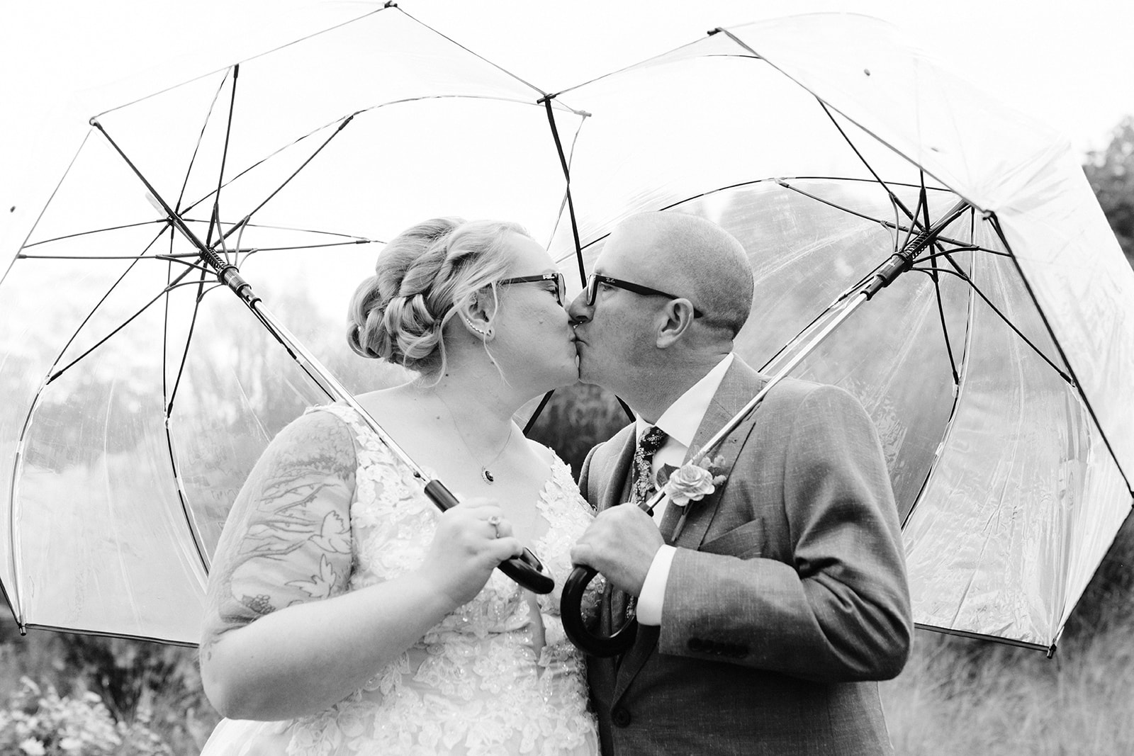 clear umbrellas on a wedding day in Michigan